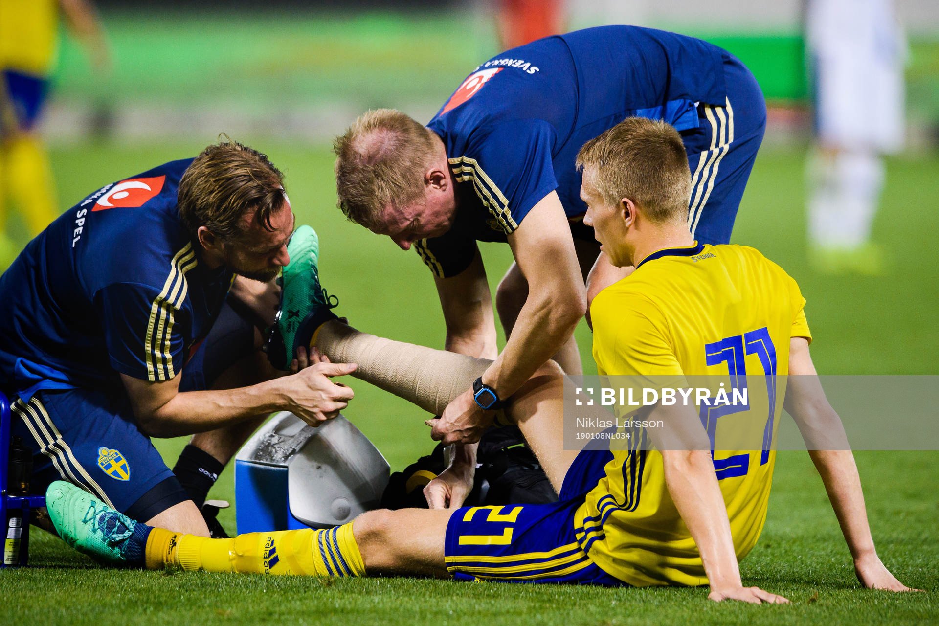 Jonathan Augustinsson of Sweden receives help after injuring his leg during the international friendly football match between Sweden and Finland on January 8, 2019 in Doha.