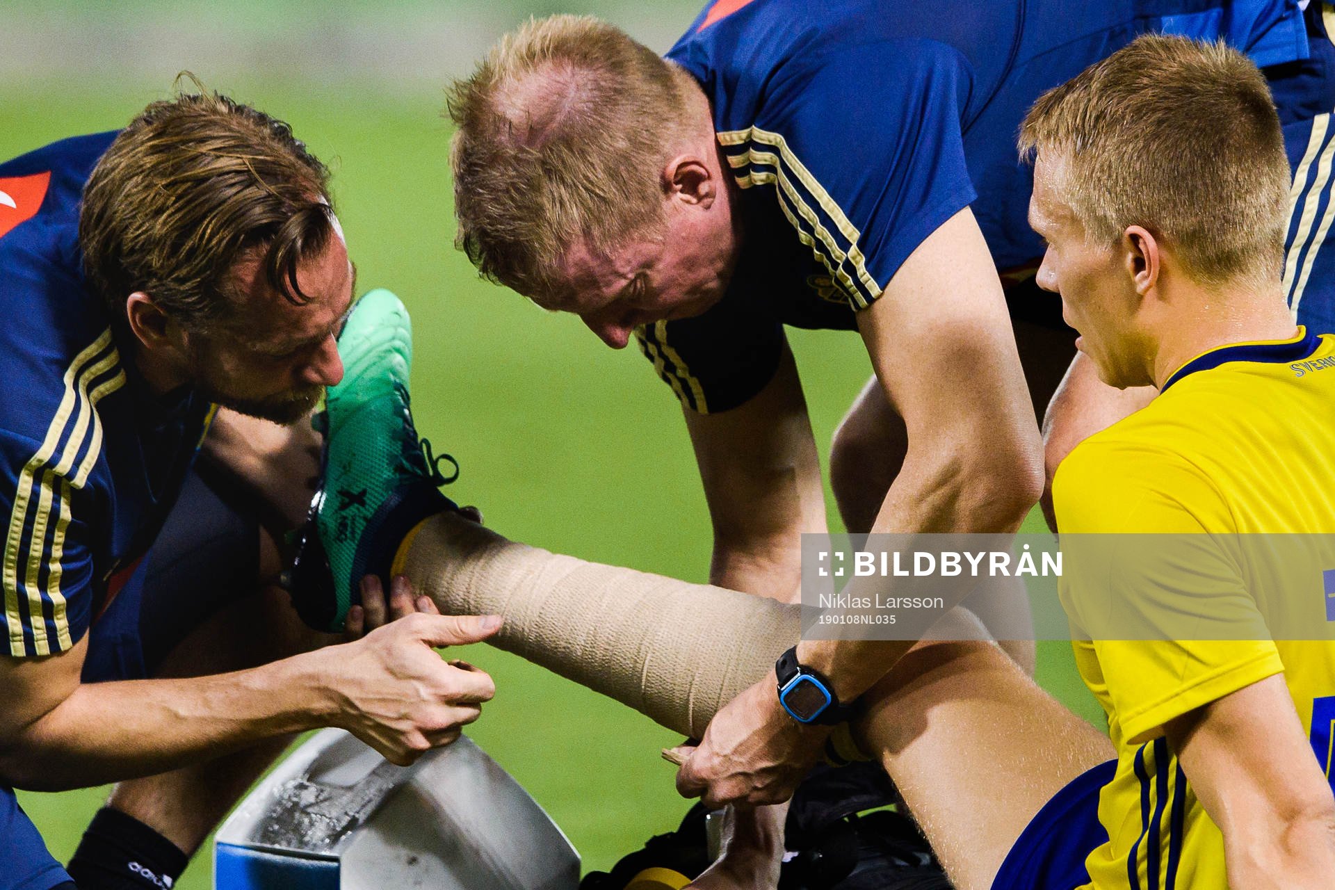 Jonathan Augustinsson of Sweden receives help after injuring his leg during the international friendly football match between Sweden and Finland on January 8, 2019 in Doha.