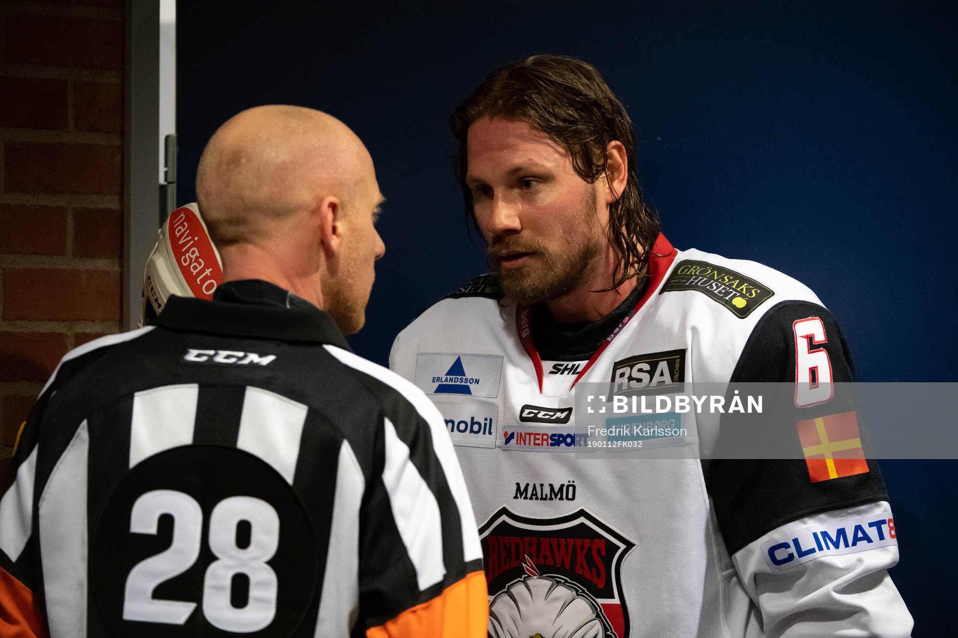 Domare Mikael Holm och Malmö Redhawks Stefan Warg samtalar