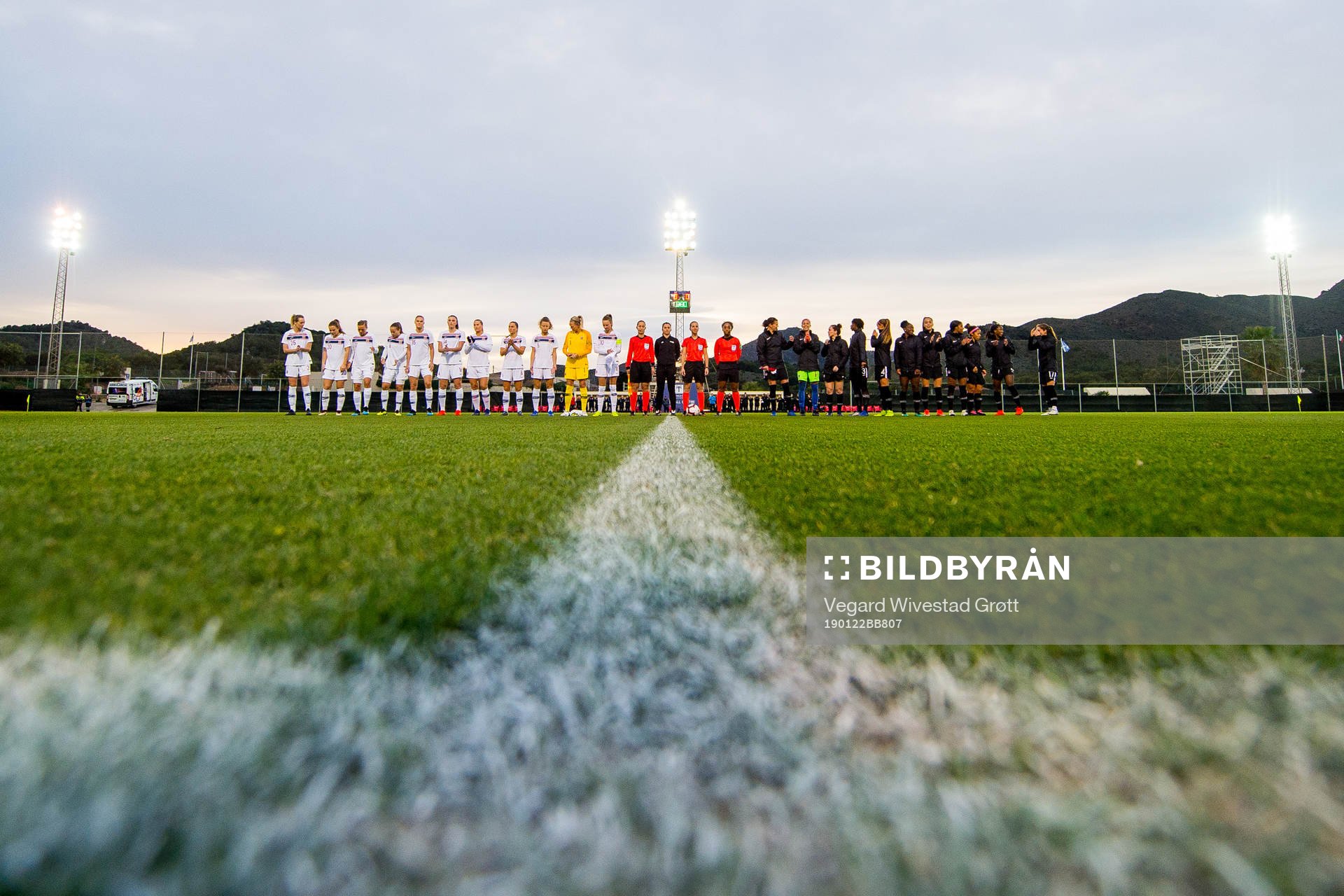 Players of Norway and Canada line up