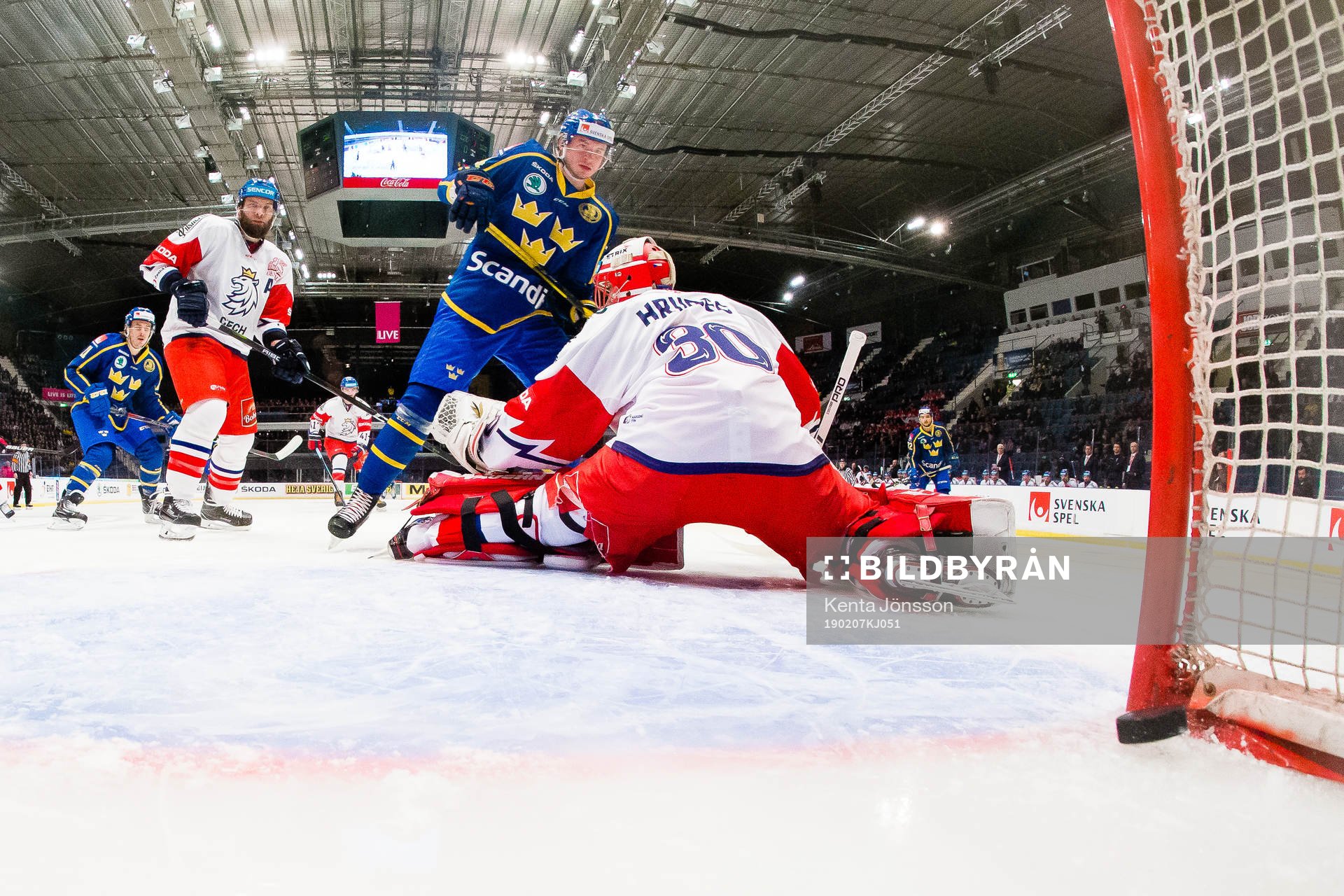 Emil Bemström of Sweden scores 0-1 behind goaltender Simon
