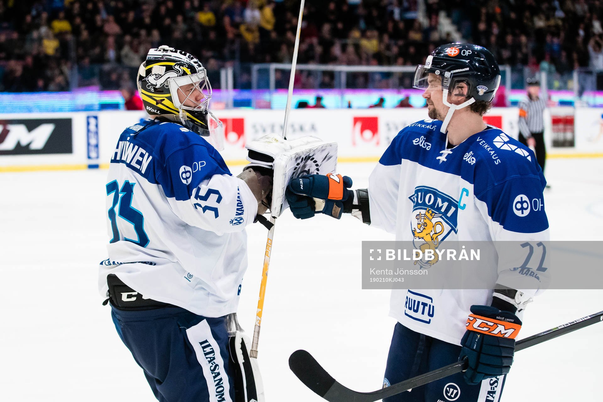 Goaltender Veini Vehviläinen and Janne Pesonen of Finland