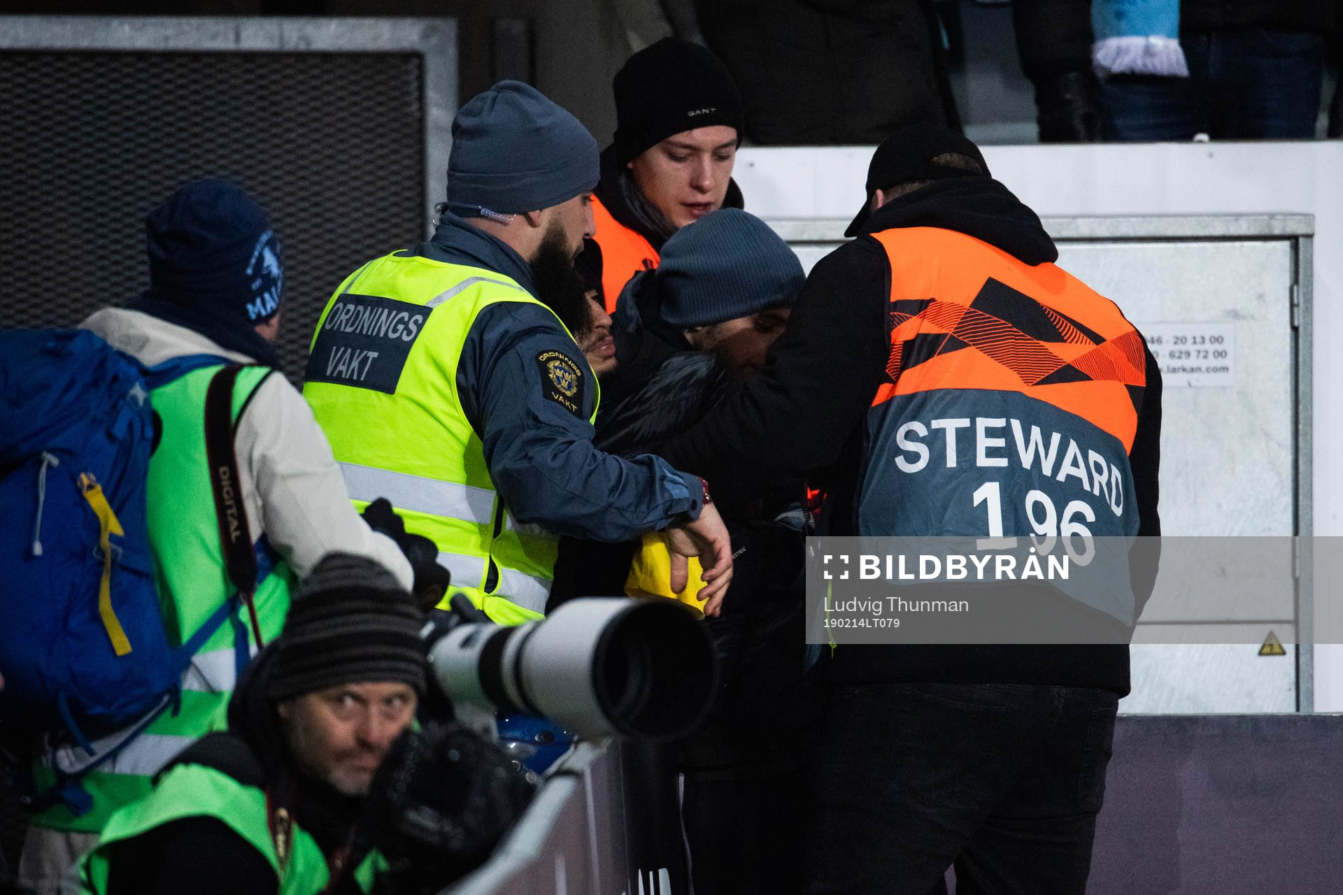 Security personel handles a pitch invader