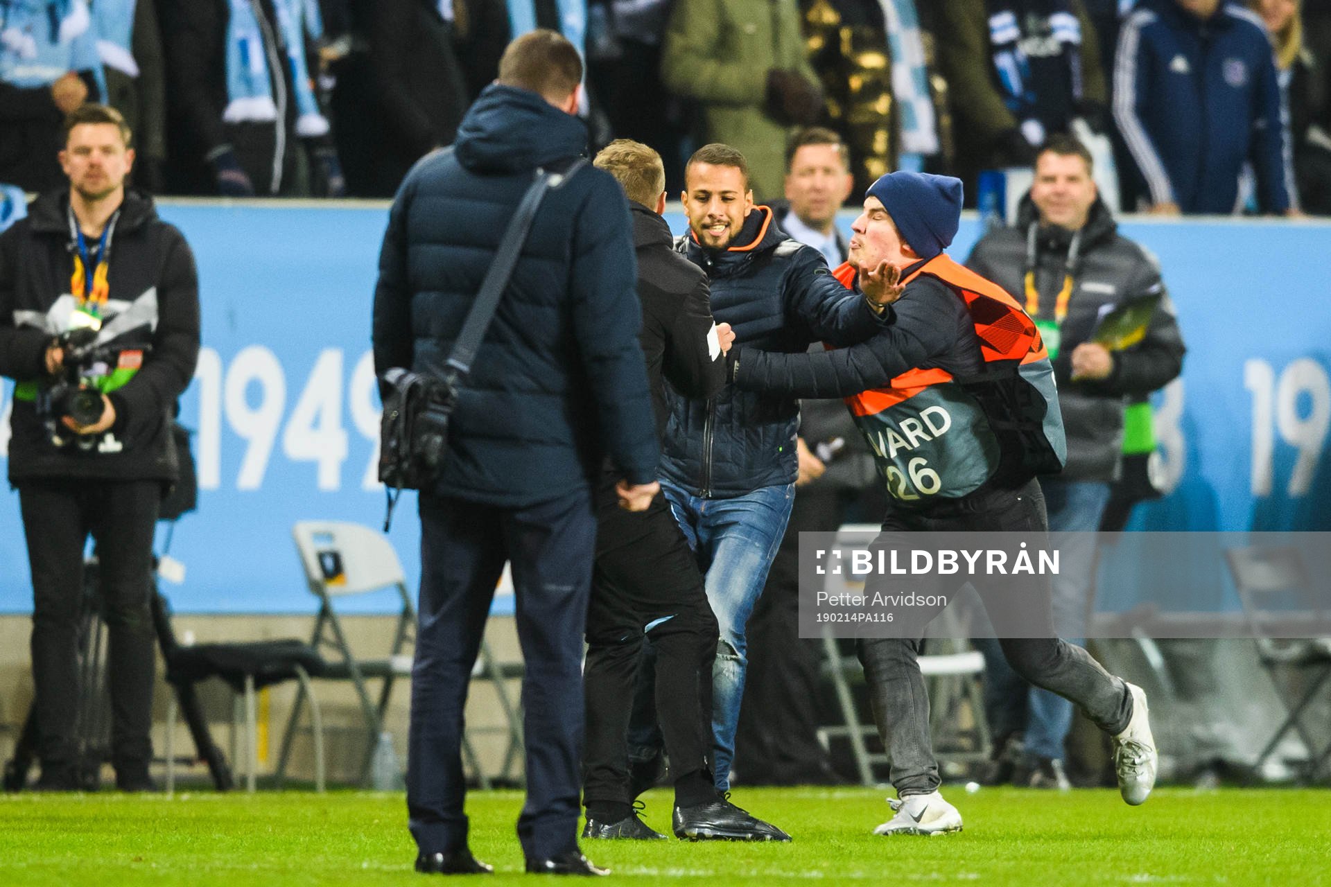 A supporter invades the pitch