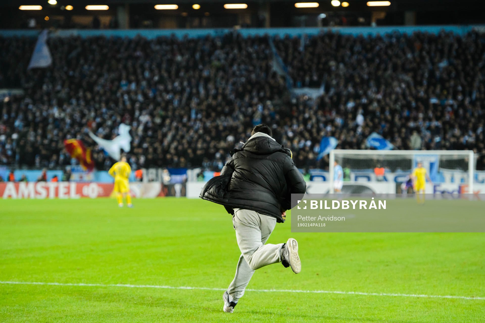 A supporter invades the pitch