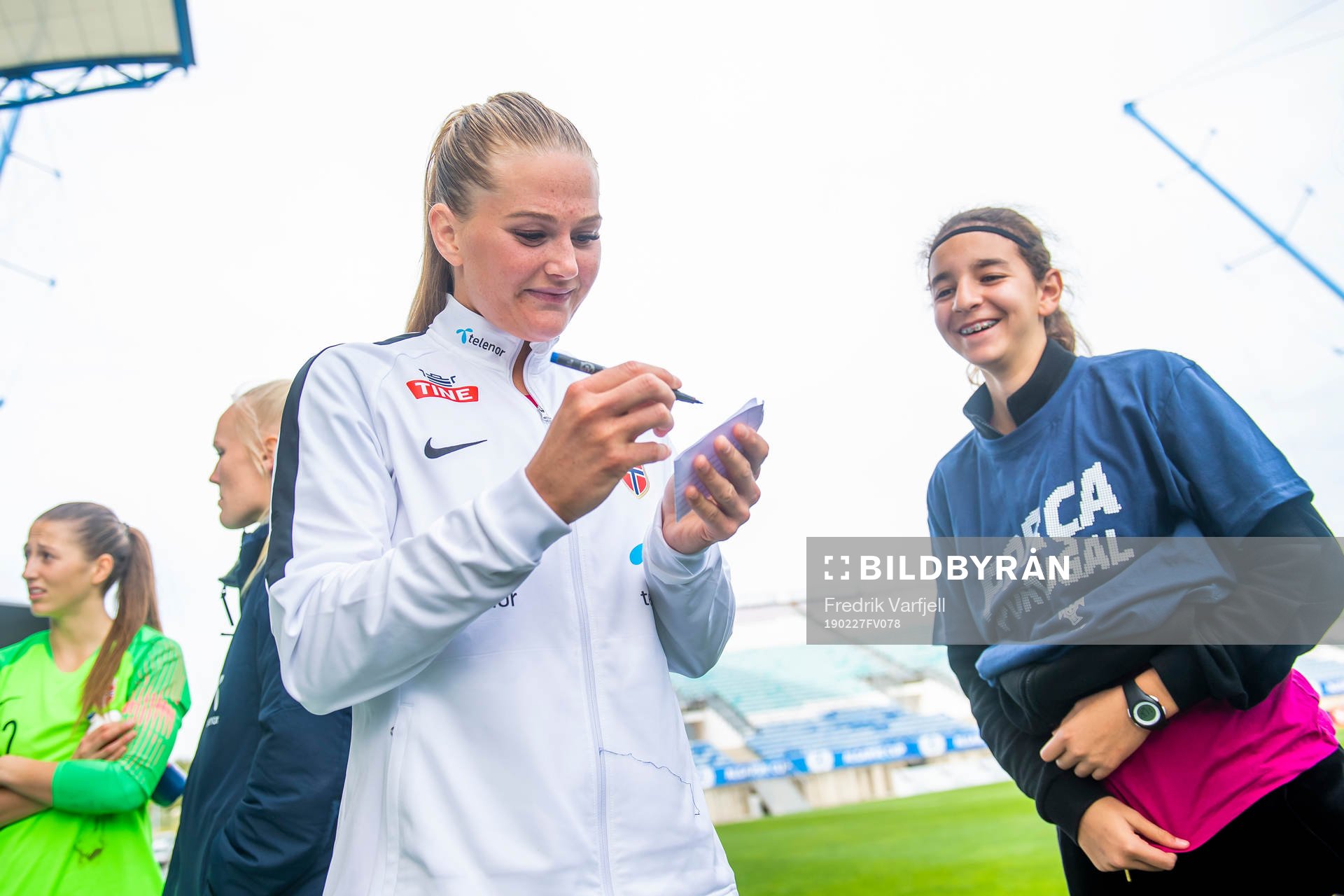 Lisa-Marie Karlseng Utland of Norway writes autographs