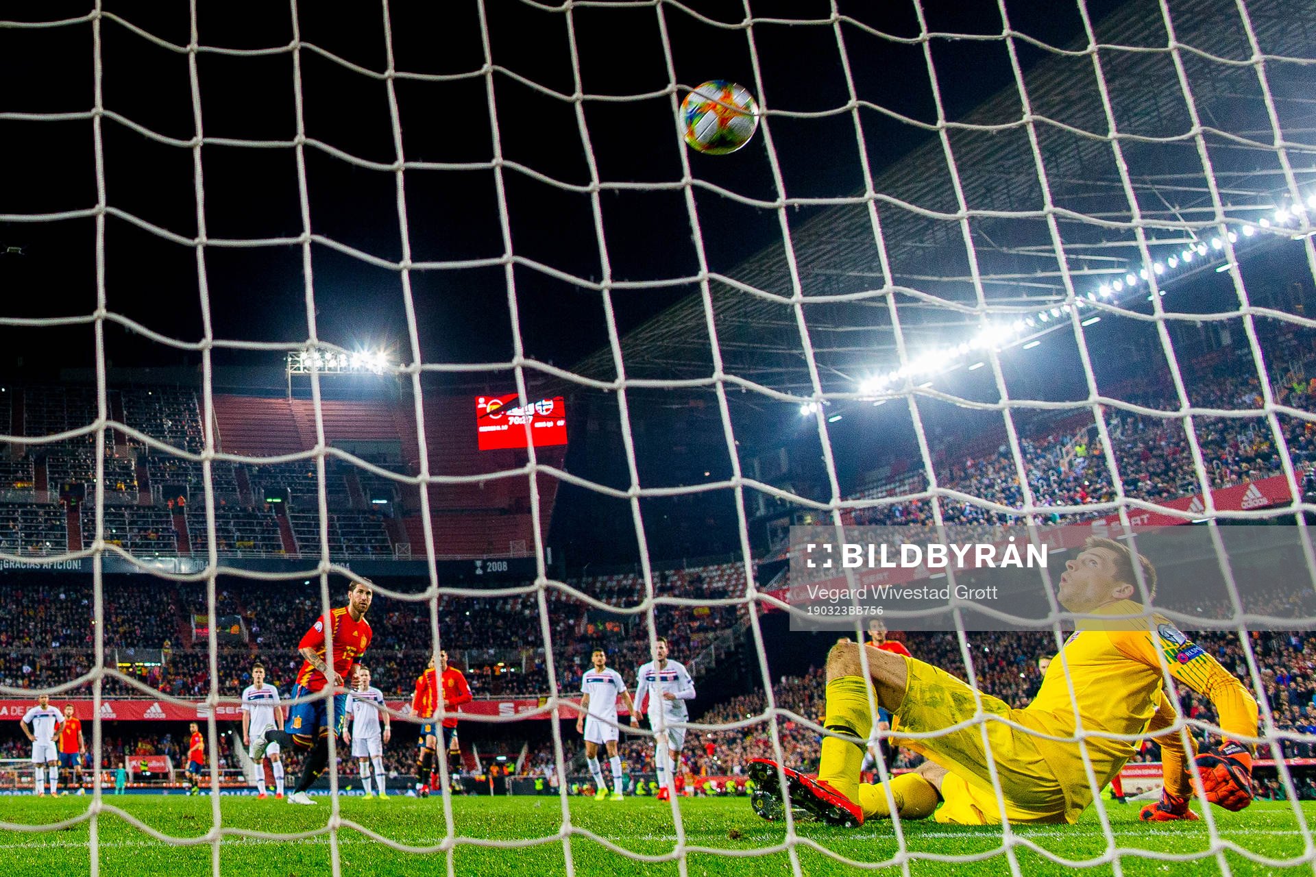 Sergio Ramos of Spain scores 2-1 behind goalkeeper Rune