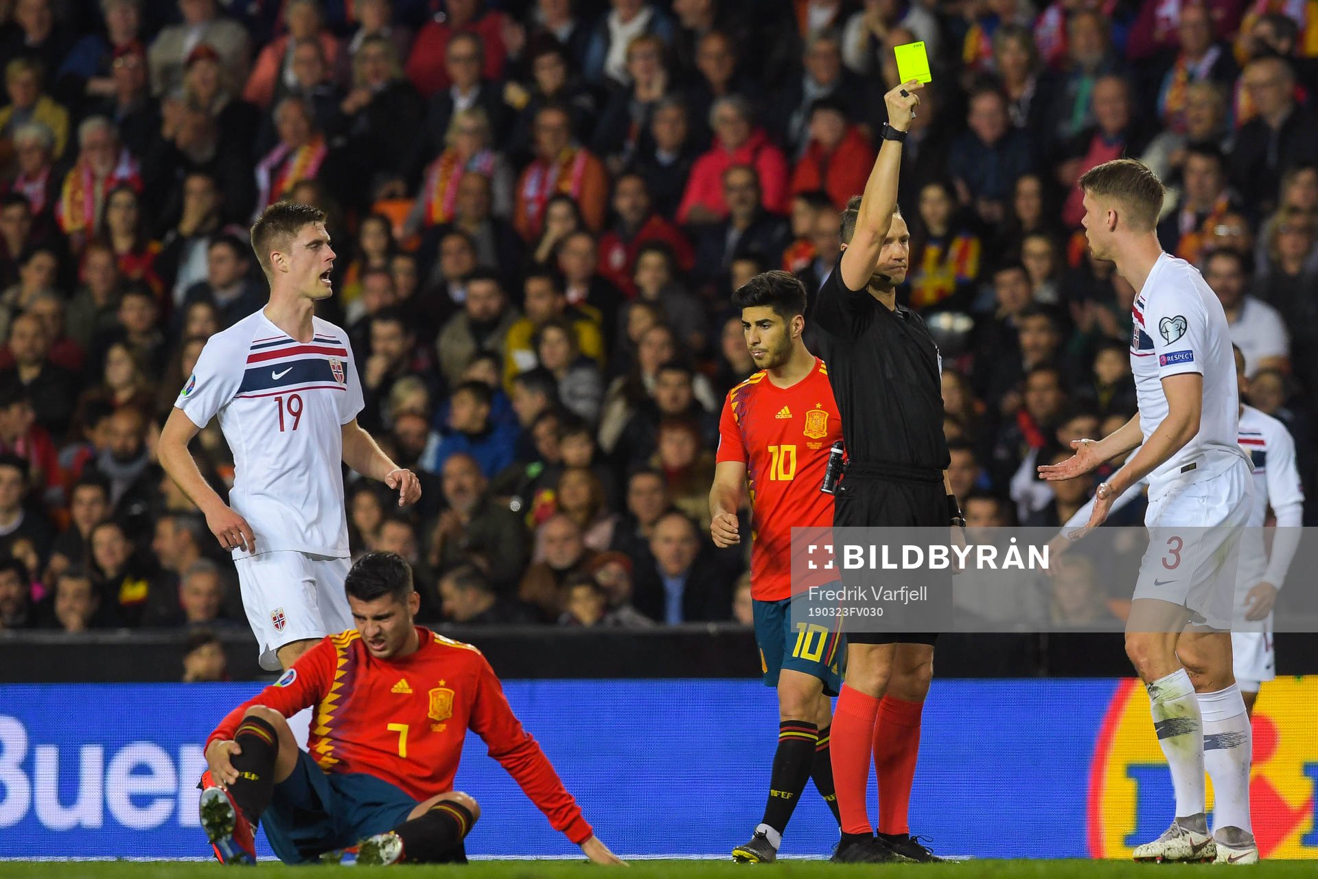 Kristoffer Ajer of Norway receives a yellow card