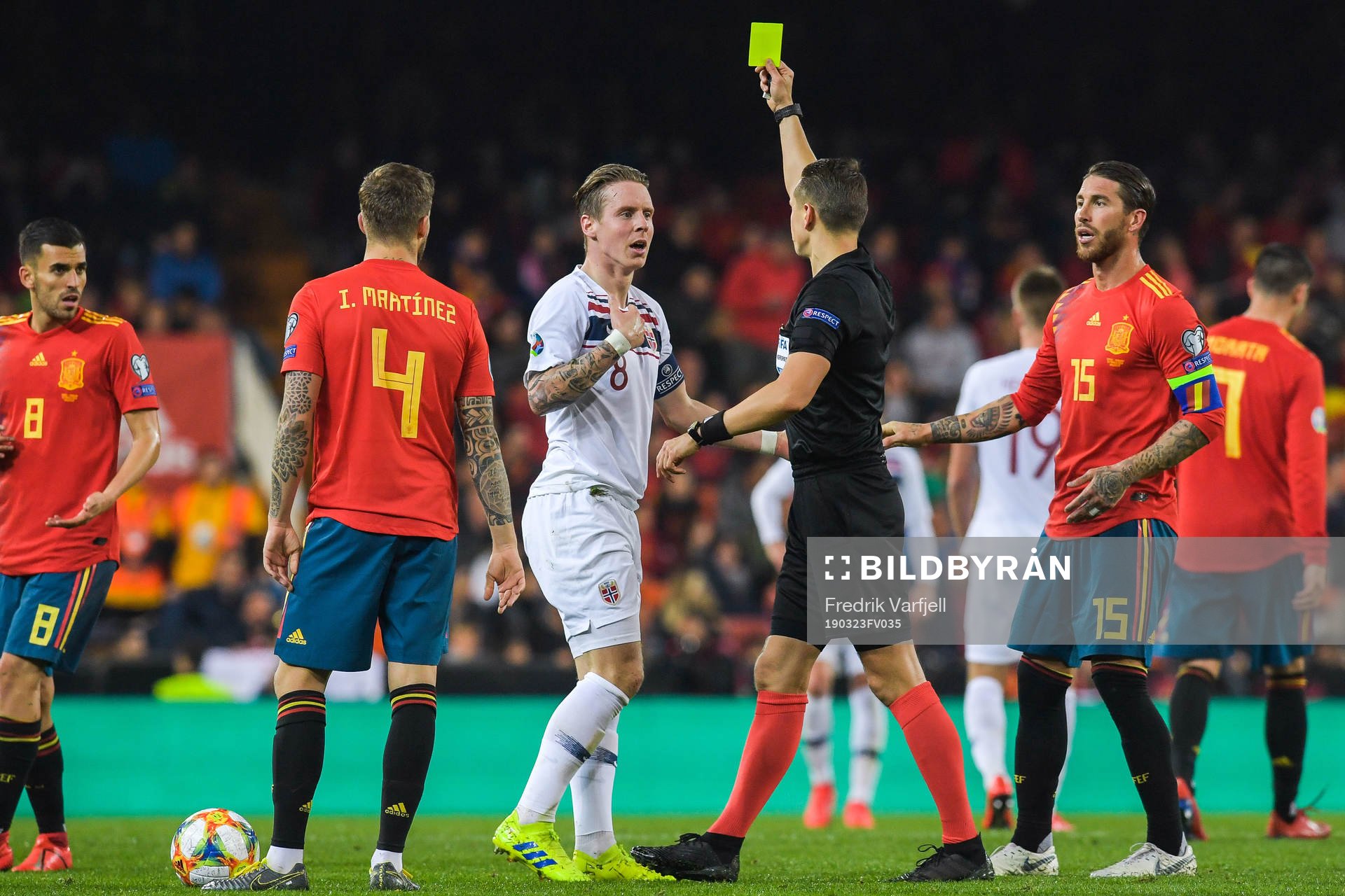 Stefan Johansen of Norway receives a yellow card