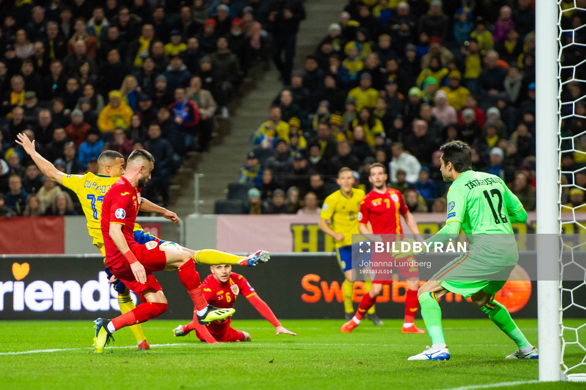 Robin Quaison of Sweden scores 1-0 behind goalkeeper