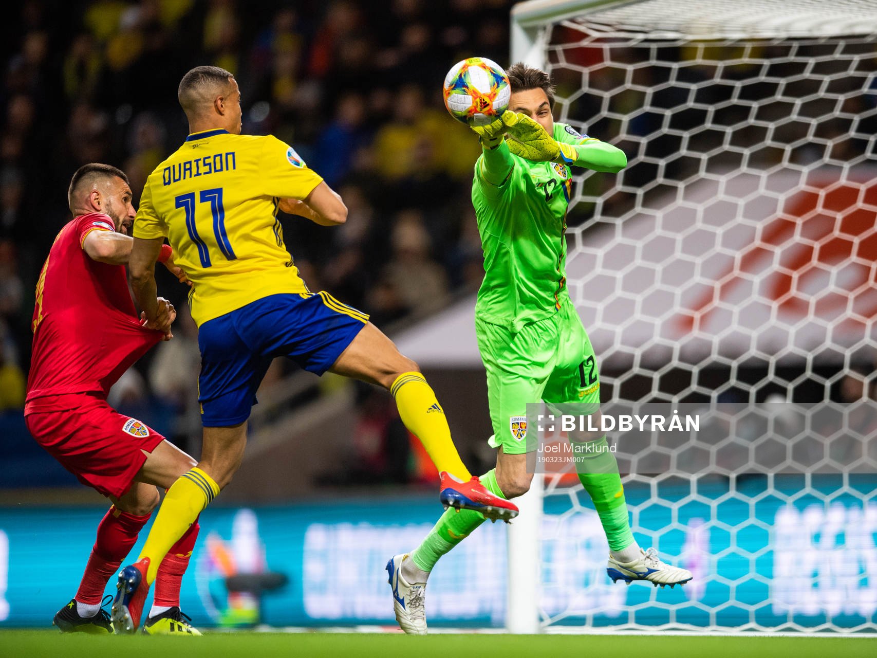 Robin Quaison of Sweden challenges goalkeeper Ciprian