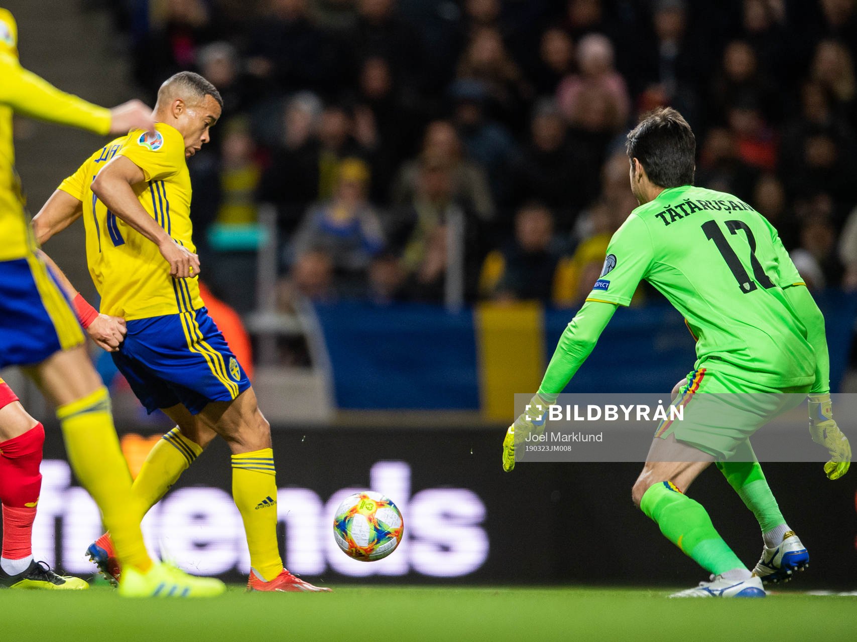 Robin Quaison of Sweden scores 1-0 behind goalkeeper