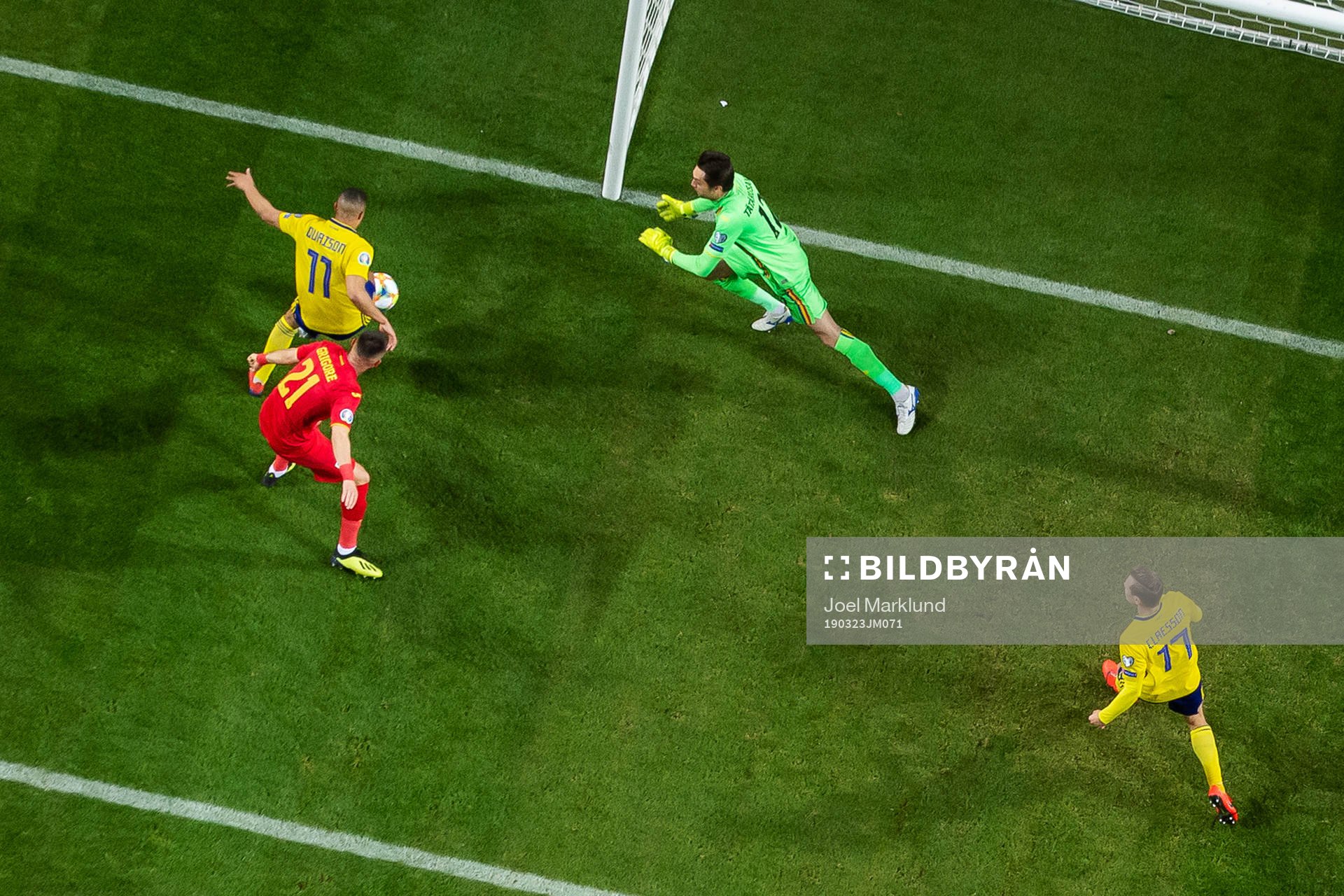 Robin Quaison of Sweden scores 1-0 behind goalkeeper