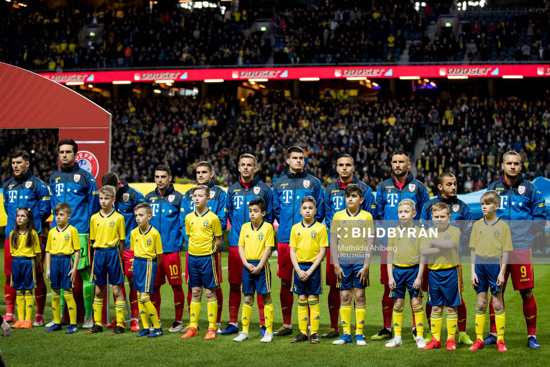 Players of Romania with mascots ahead the UEFA Euro