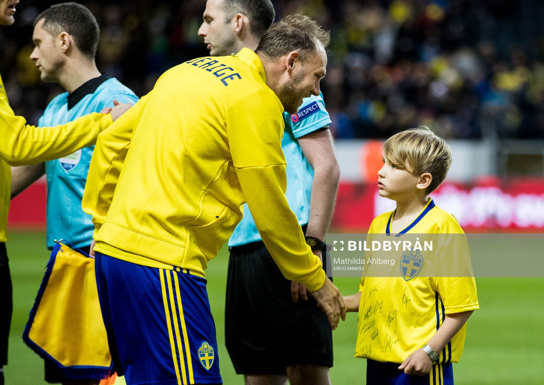 Andreas Granqvist of Sweden, Oscar Petersson from Min stora dag shakes hands ahead of the UEFA Euro Qualifier football match between Sweden and Romania on March 23, 2019 in Stockholm.