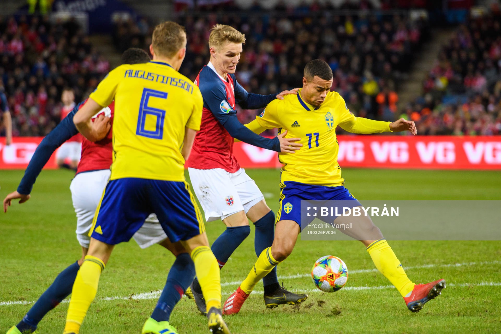 Martin Ødegaard of Norway in action with Robin Quaison of
