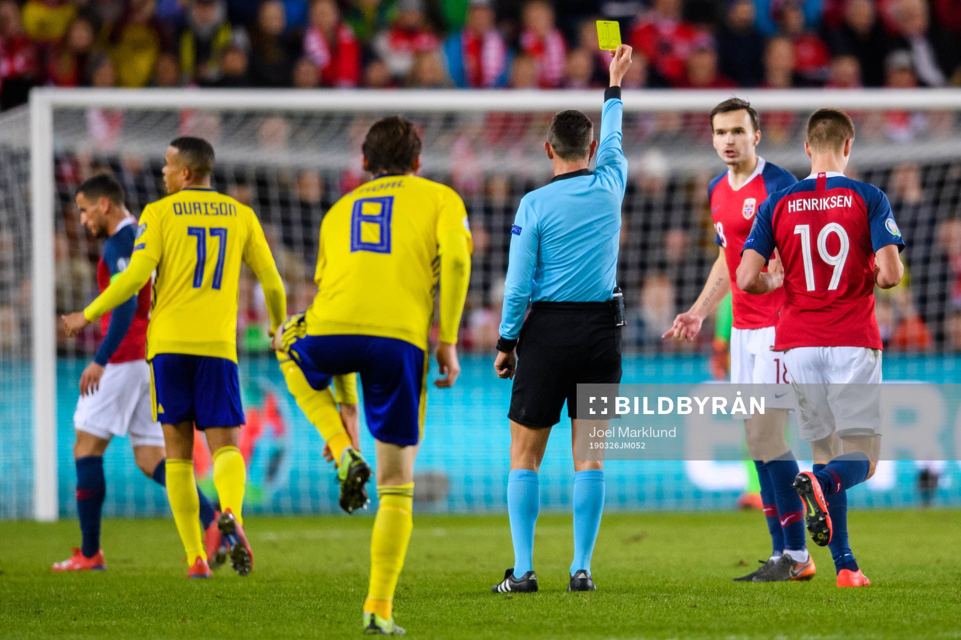 Ole Kristian Selnæs of Norway is shown a yellow card