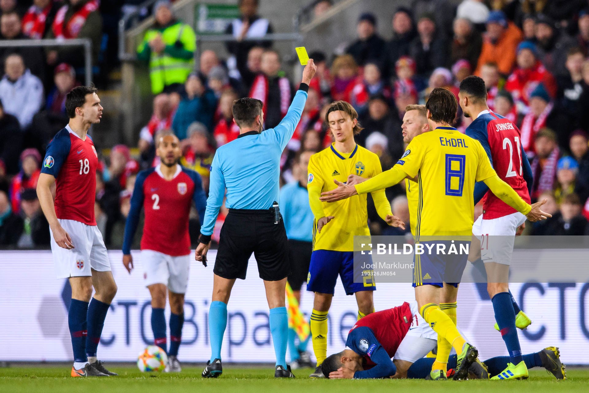 Kristoffer Olsson of Sweden is shown a yellow card