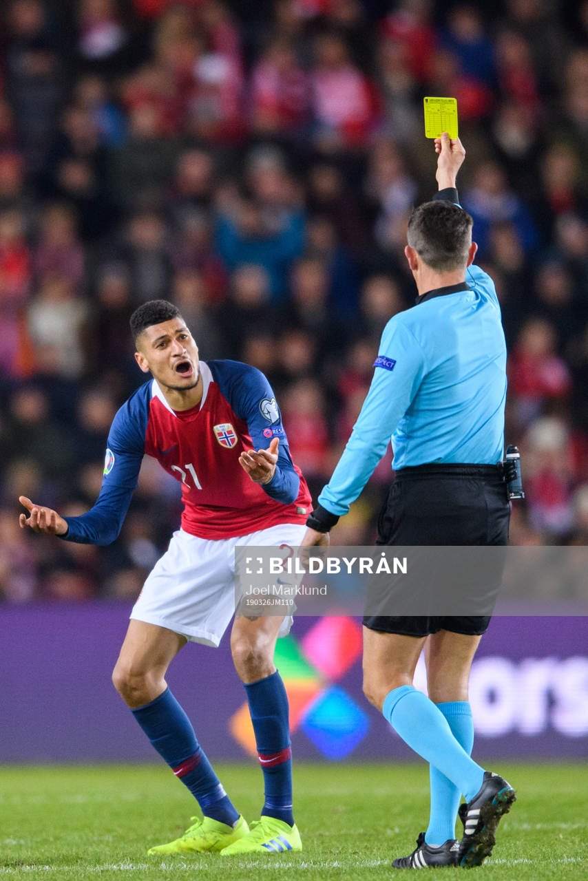 Bjørn Maars Johnsen of Norway is shown a yellow card