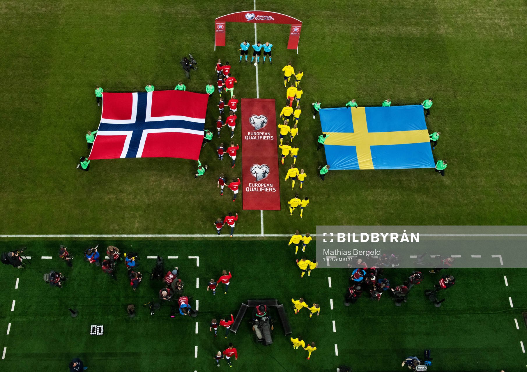 Players of Norway and of Sweden enter the pitch