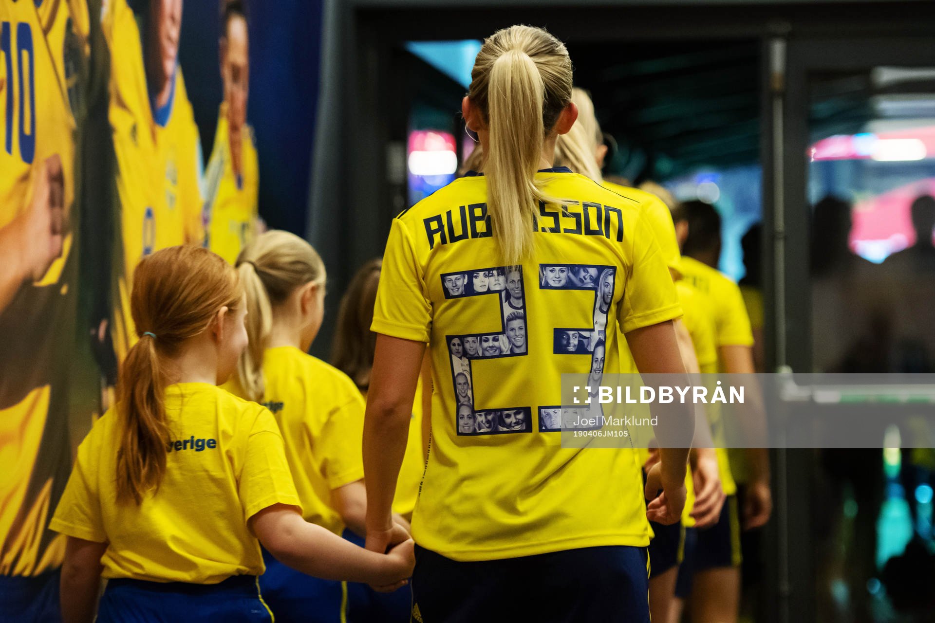 Elin Rubensson of Sweden enter the field in hand with a
