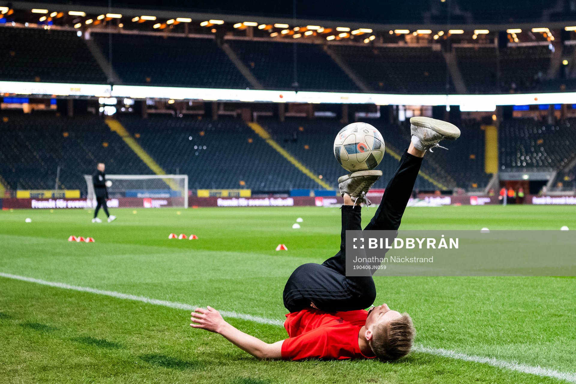 A kid performs football tricks