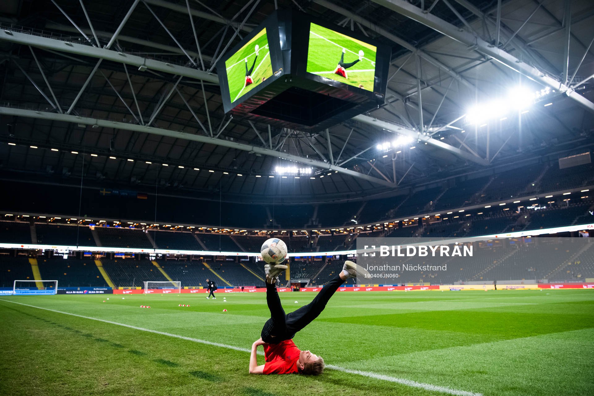 A kid performs football tricks
