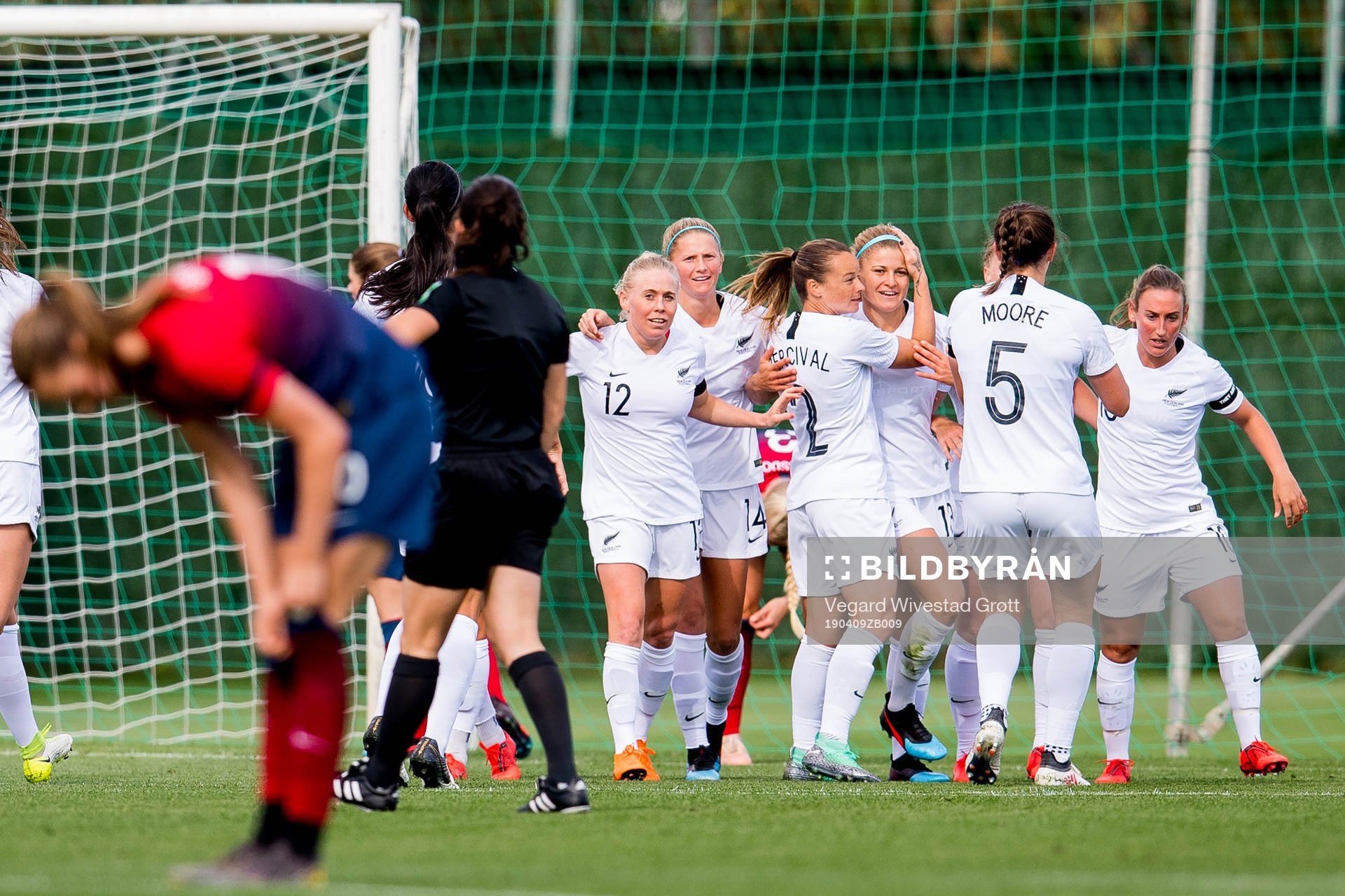 Rosie White of New Zealand celebrates with teammates Betsy