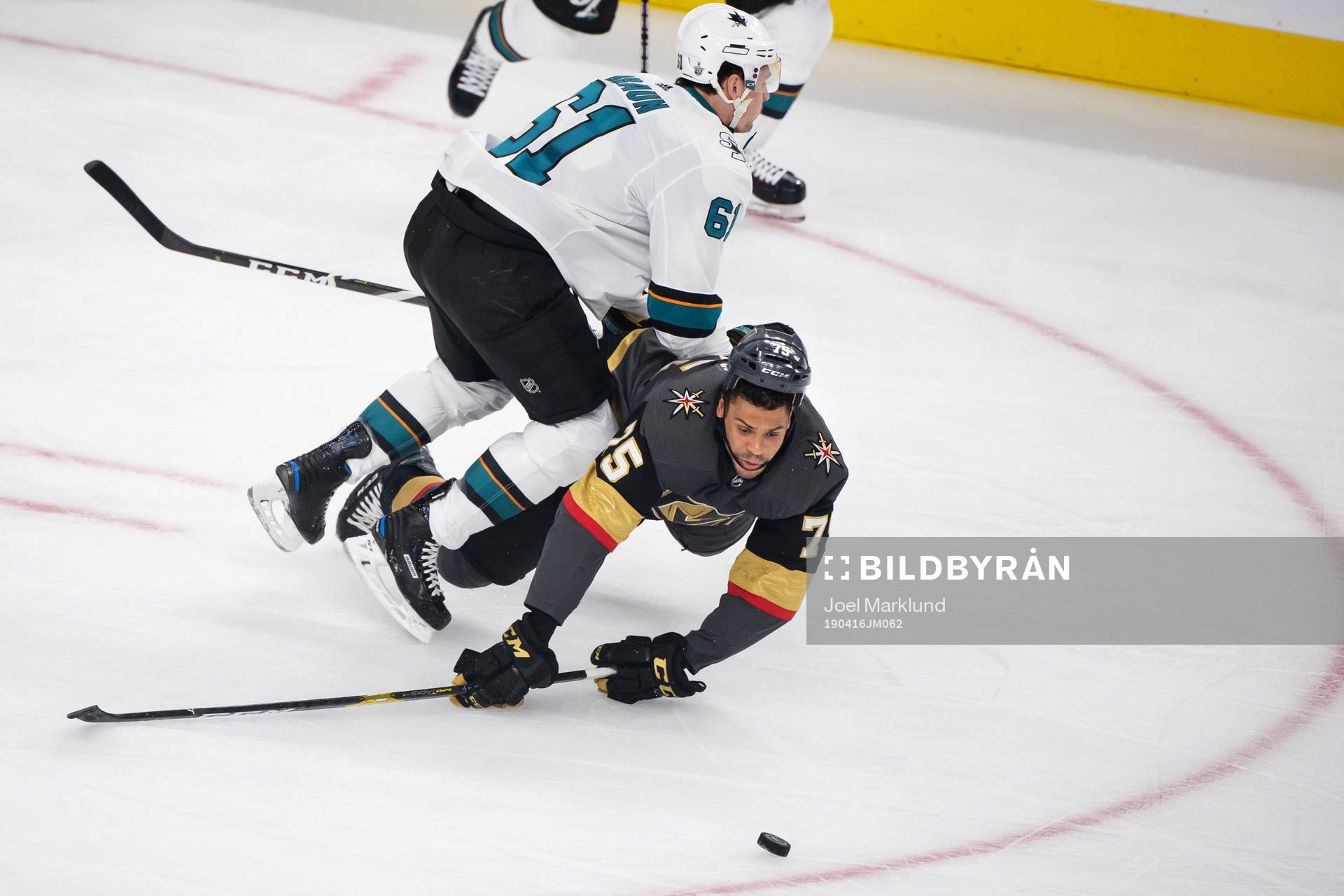 Justin Braun of San Jose Sharks tackles Ryan Reaves of