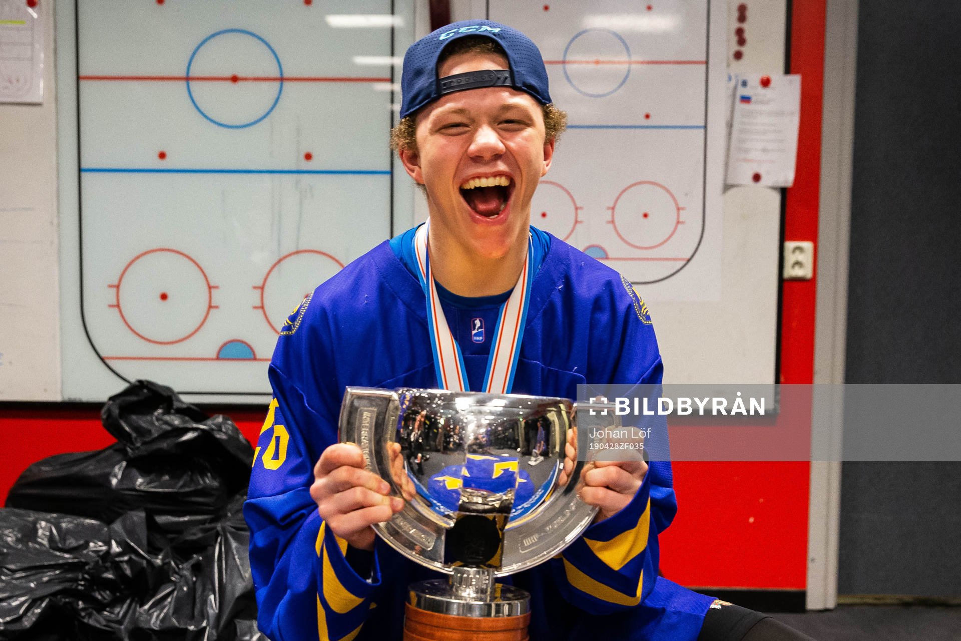 Lucas Raymond of Sweden celebrates with the trophy