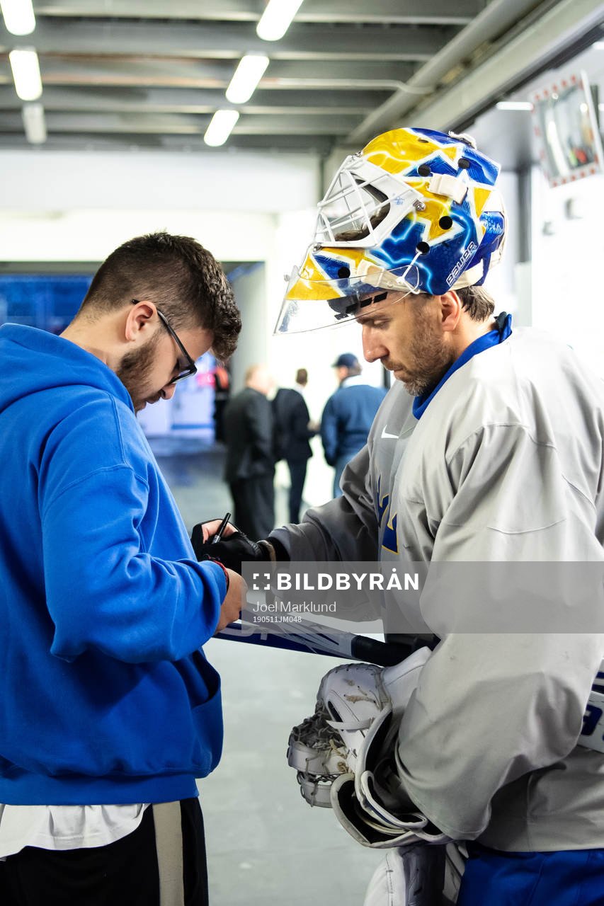 Goaltender Henrik Lundqvist of Sweden and a fan
