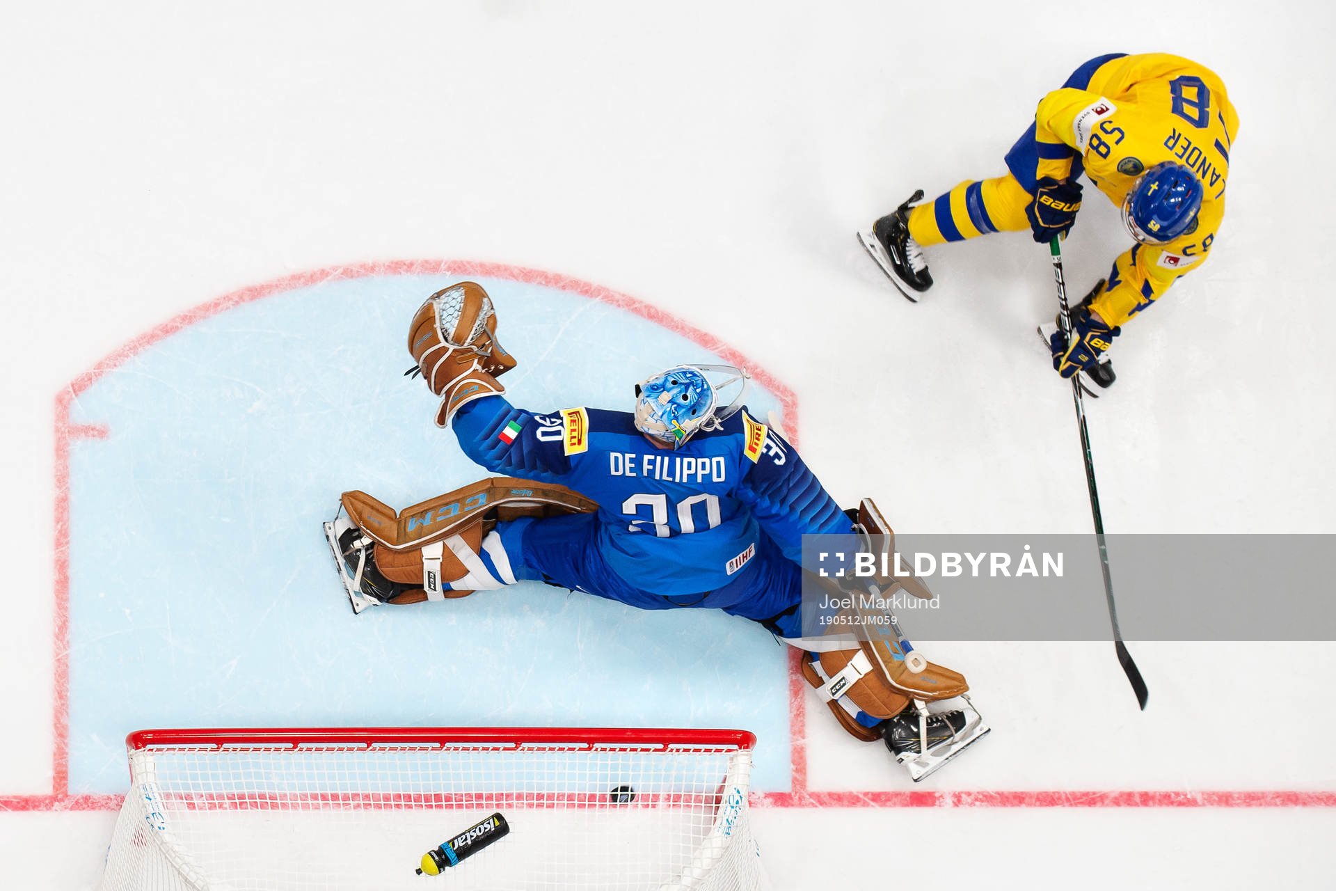 Anton Lander of Sweden scores 0-5 behind goaltender Marco