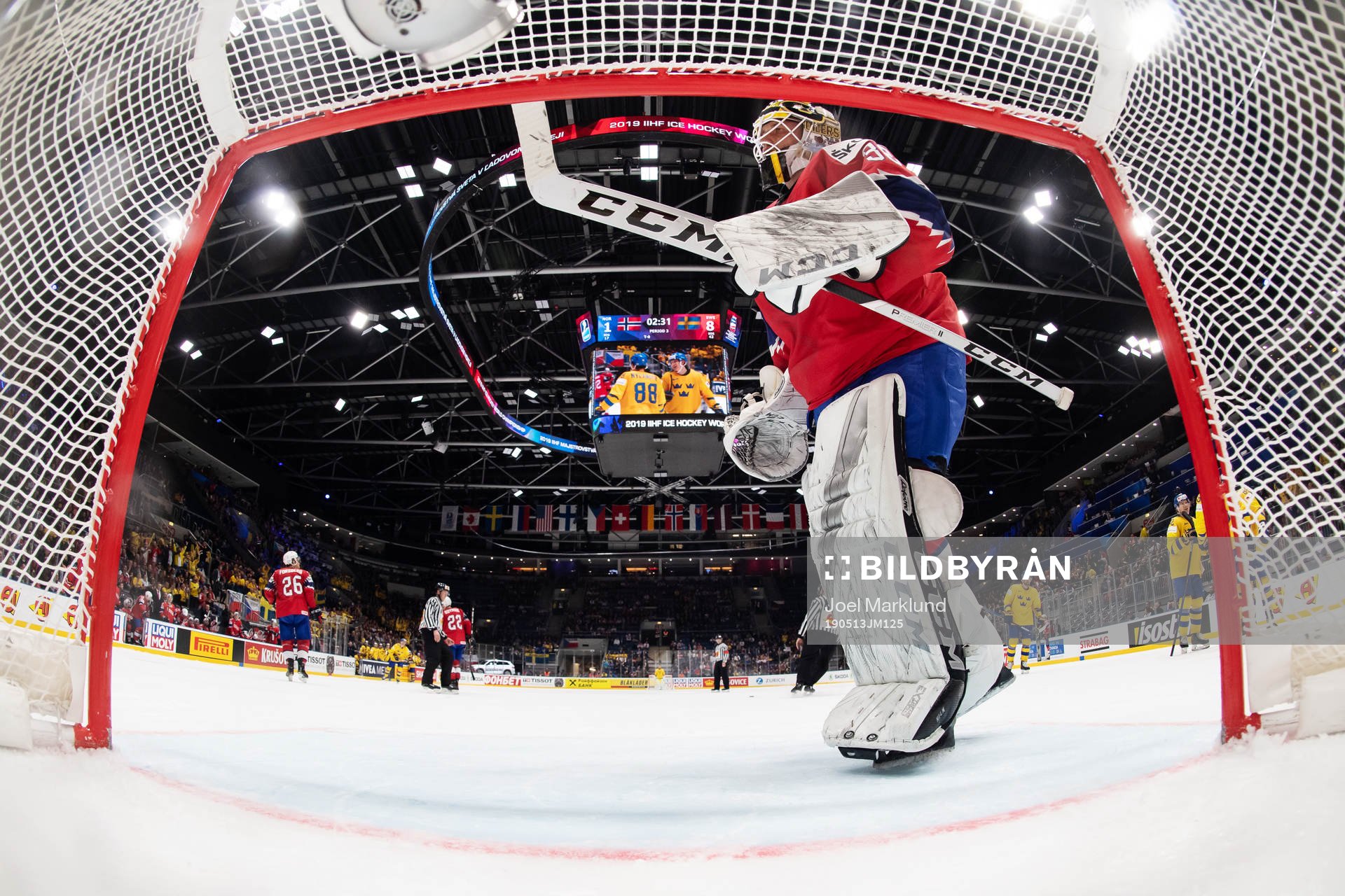 Goaltender Henrik Holm of Norway looks dejected