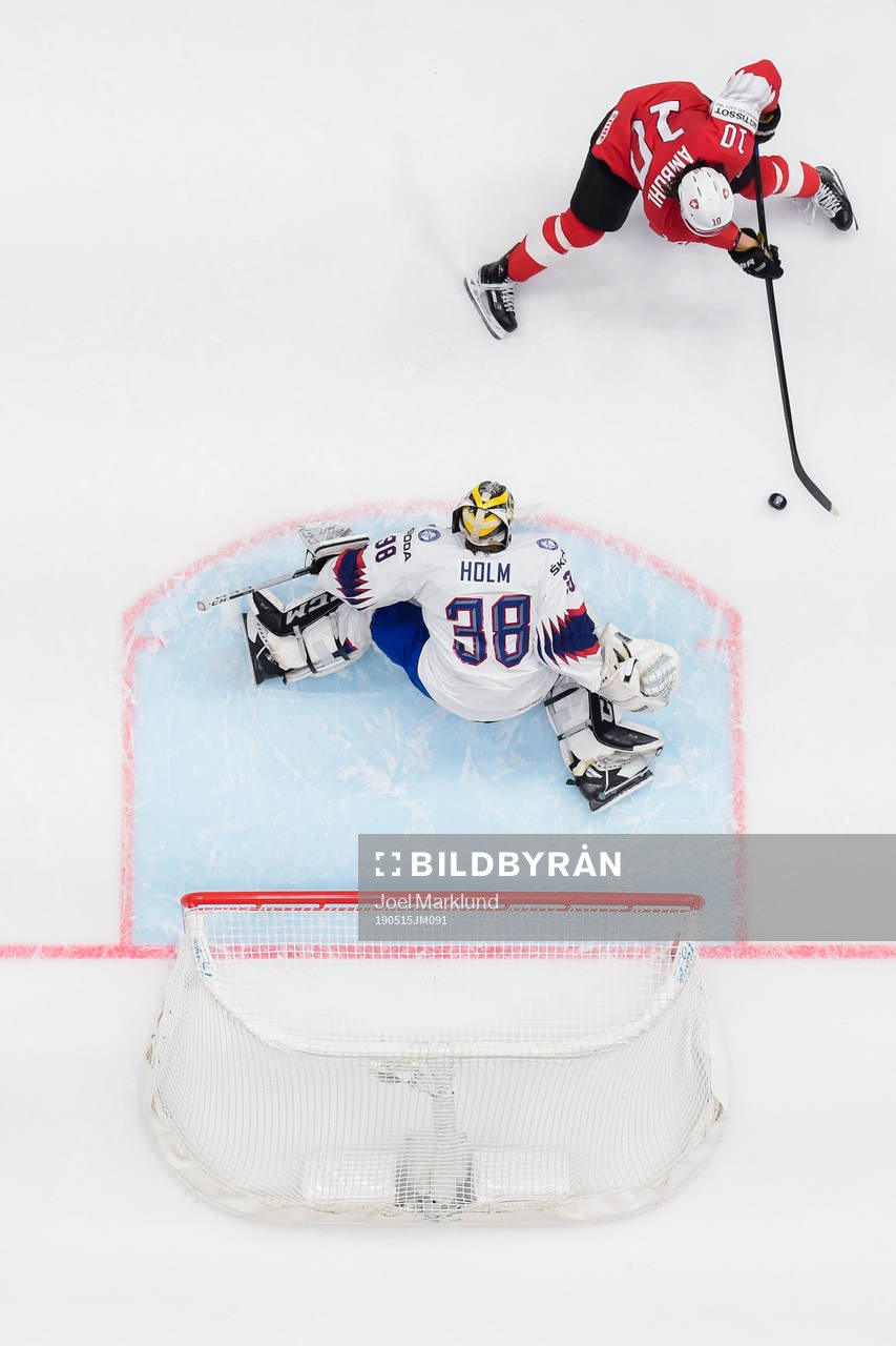 Andres Ambuhl of Switzerland scores 1-0 behind goaltender