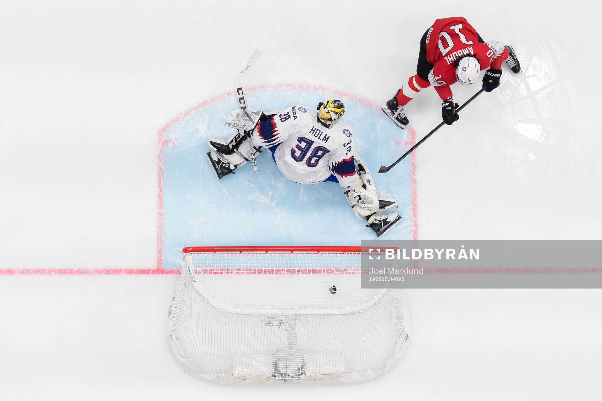 Andres Ambuhl of Switzerland scores 1-0 behind goaltender