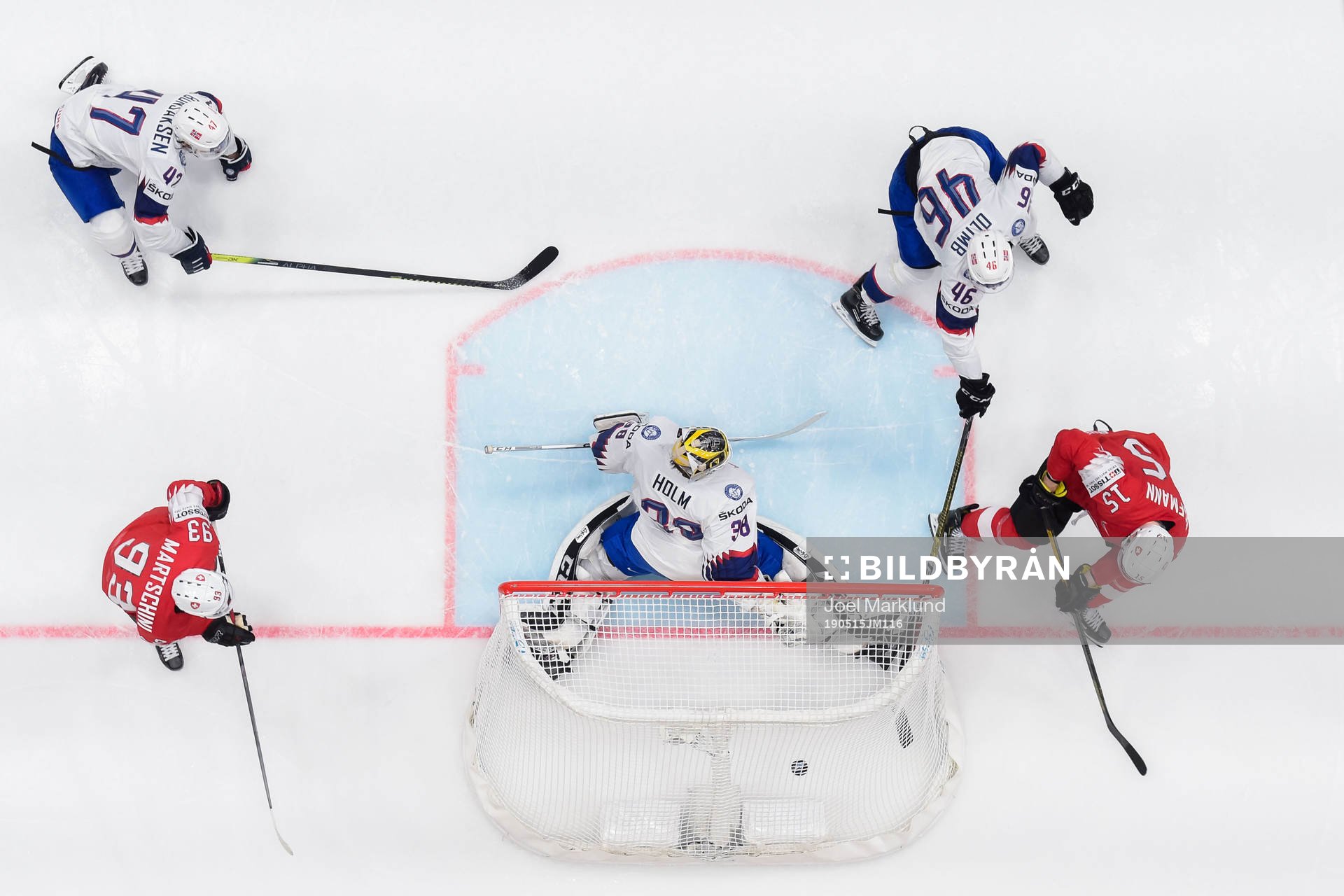 Gregory Hofmann of Switzerland scores 3-0 behind goaltender