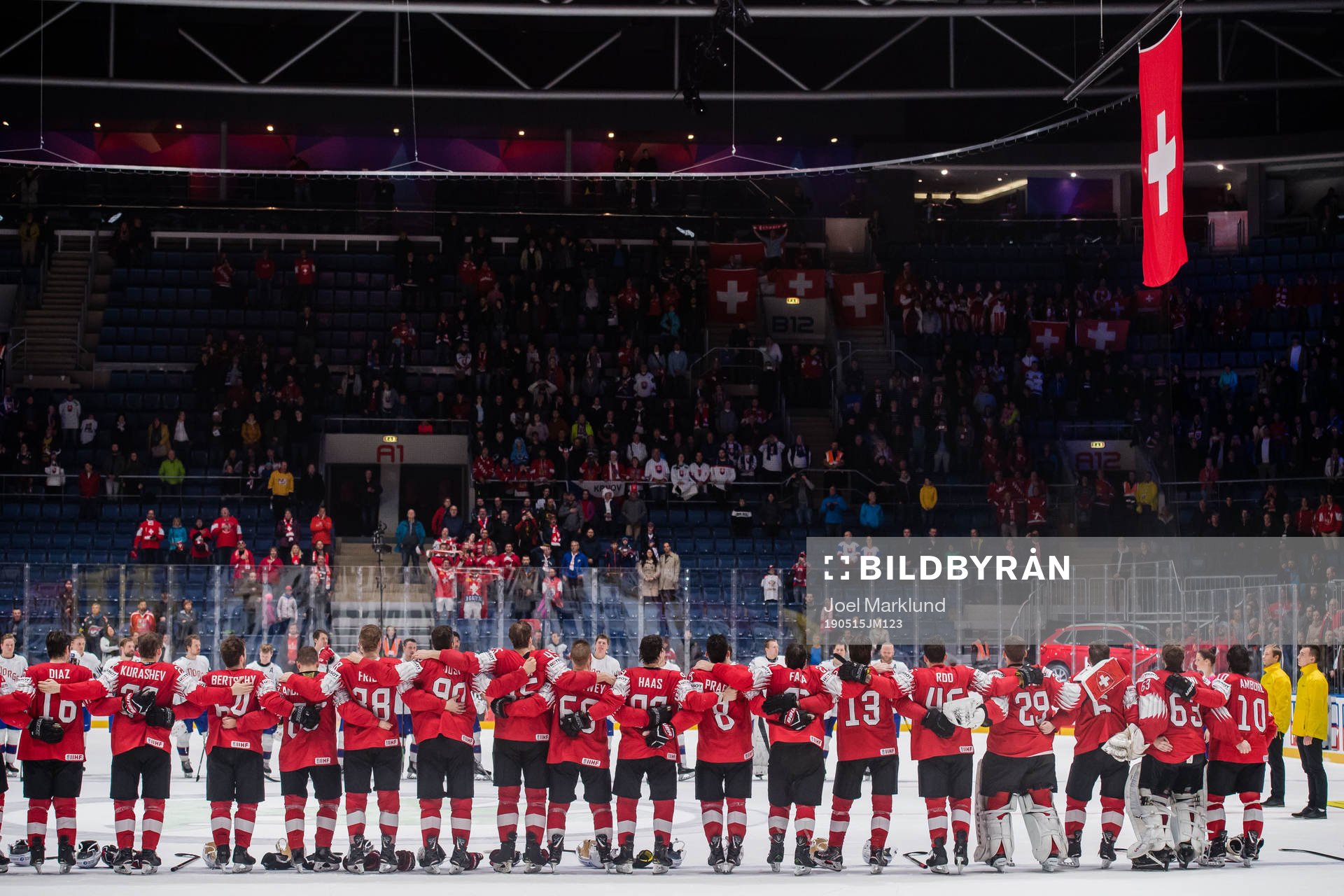 Players of Switzerland sees the Swiss flag being hoisted