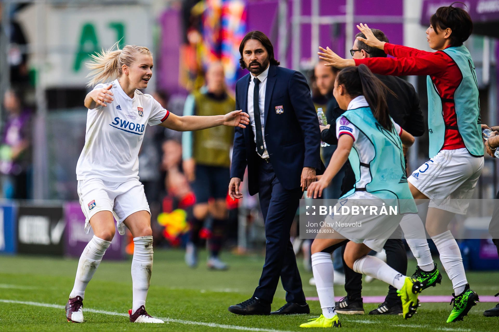 Ada Hegerberg of Lyon celebrate with teammates and Reynald Pedros, head coach,after 4-0 during the UEFA Women's Champions League final match between Lyon and Barcelona on May 18, 2019 in Budapest.