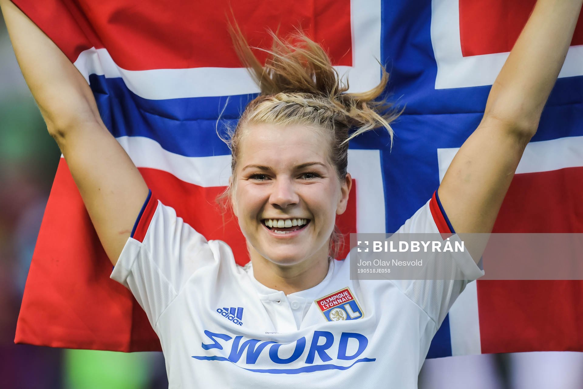 Ada Hegerberg of Lyon celebrates with a Norwegian flag