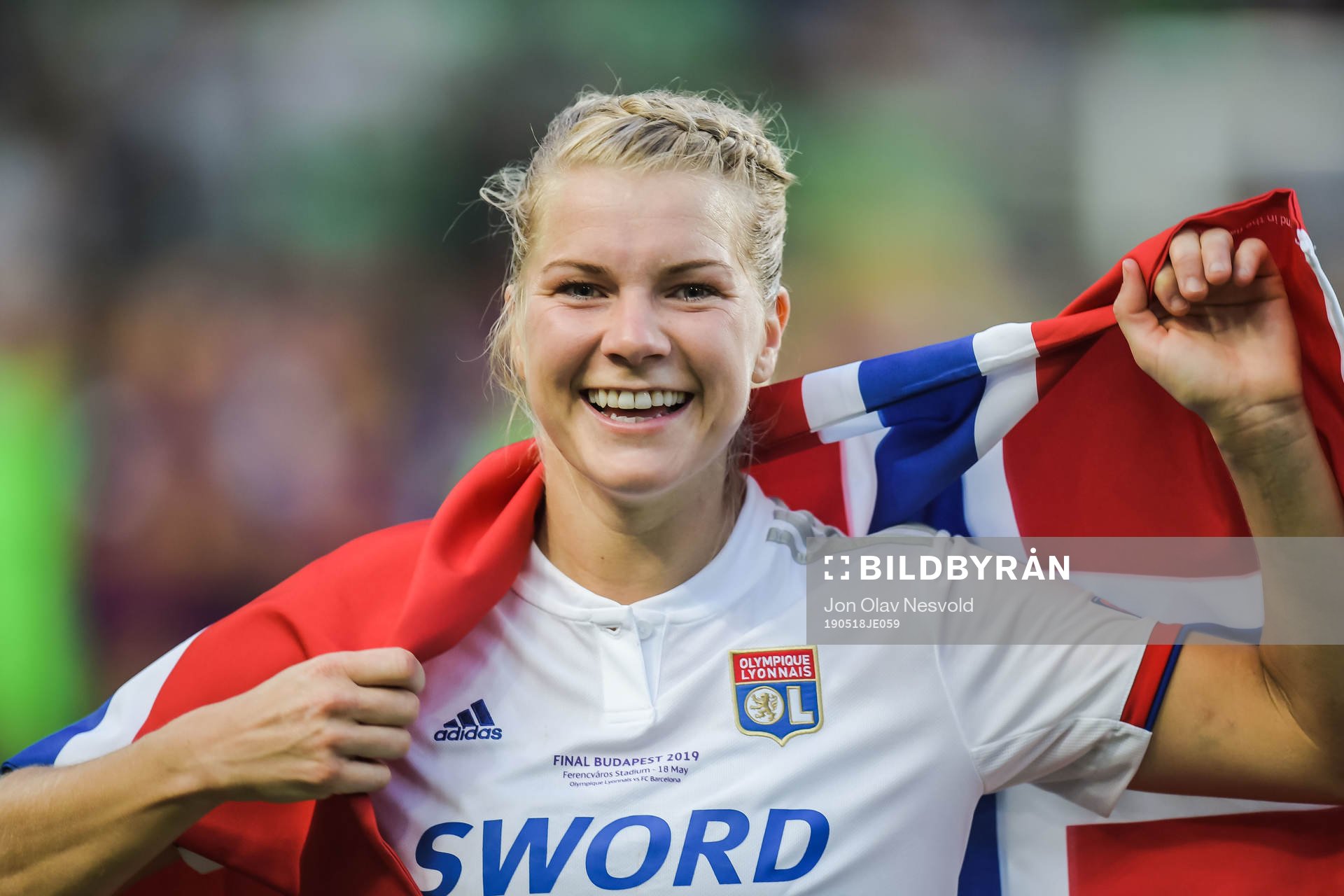 Ada Hegerberg of Lyon celebrates with a Norwegian flag
