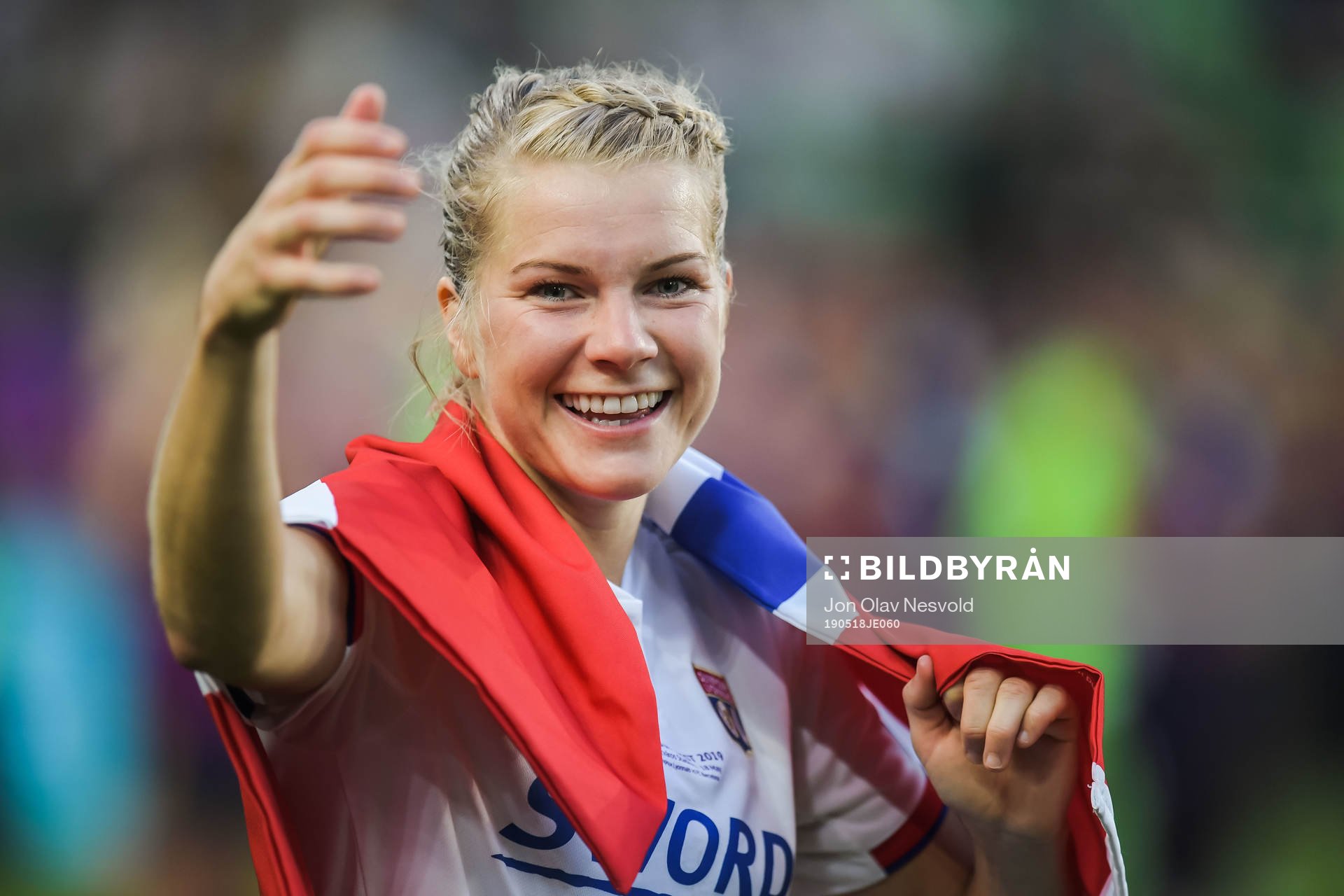 Ada Hegerberg of Lyon celebrates with a Norwegian flag