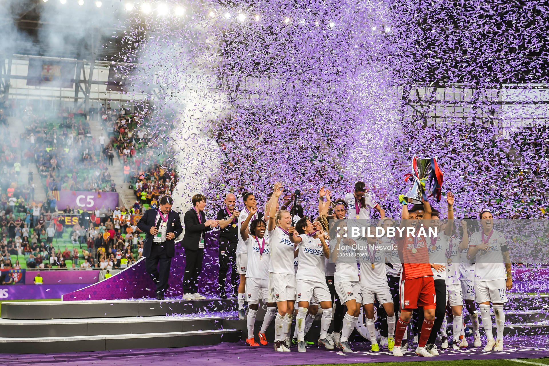Players of Lyon celebrate with the trophy
