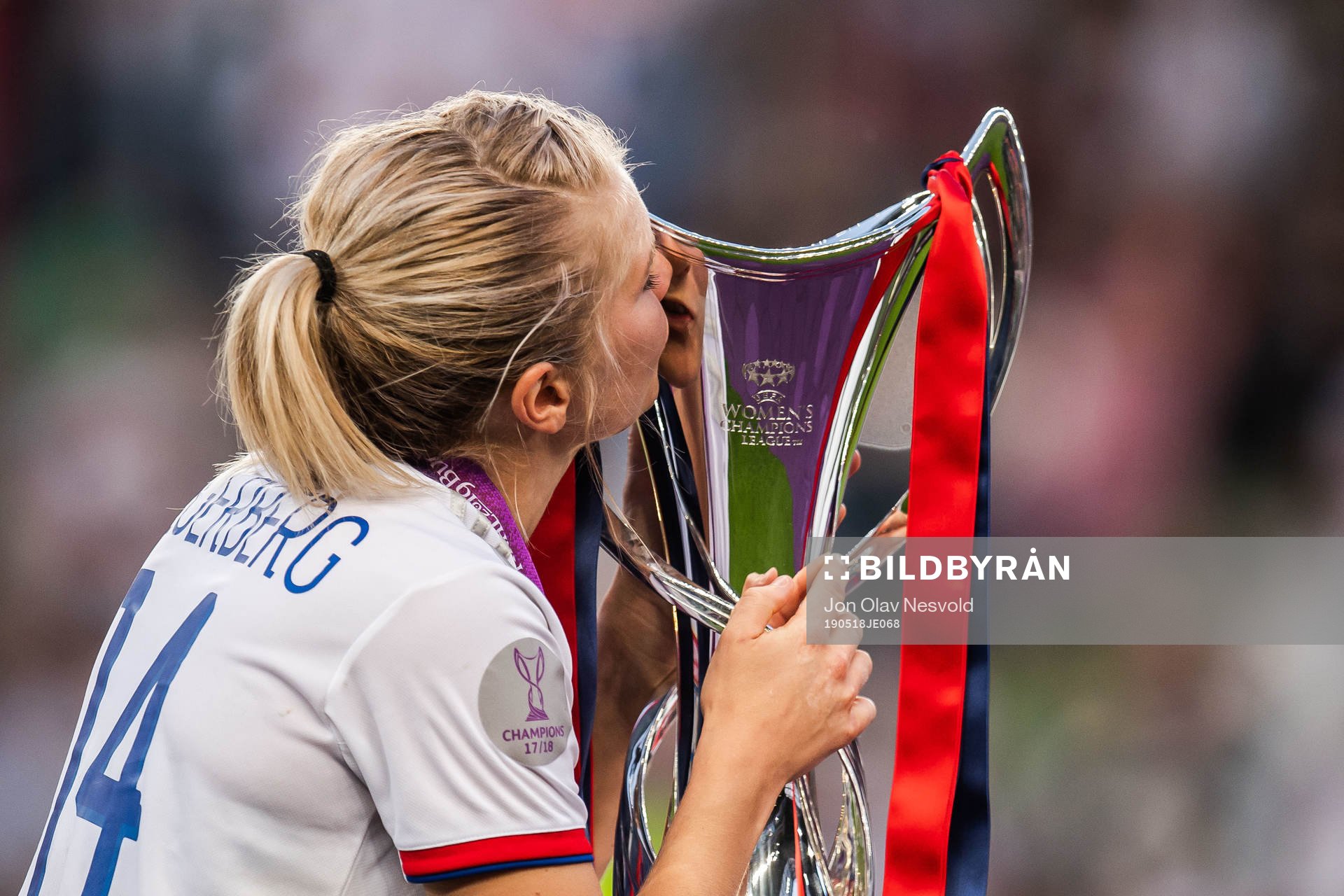 Ada Hegerberg of Lyon kisses the trophy