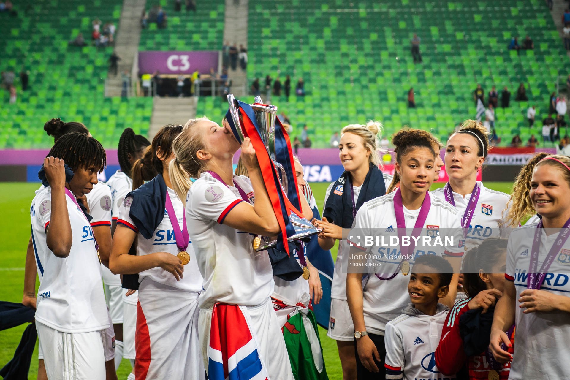 Ada Hegerberg of Lyon kisses the trophy