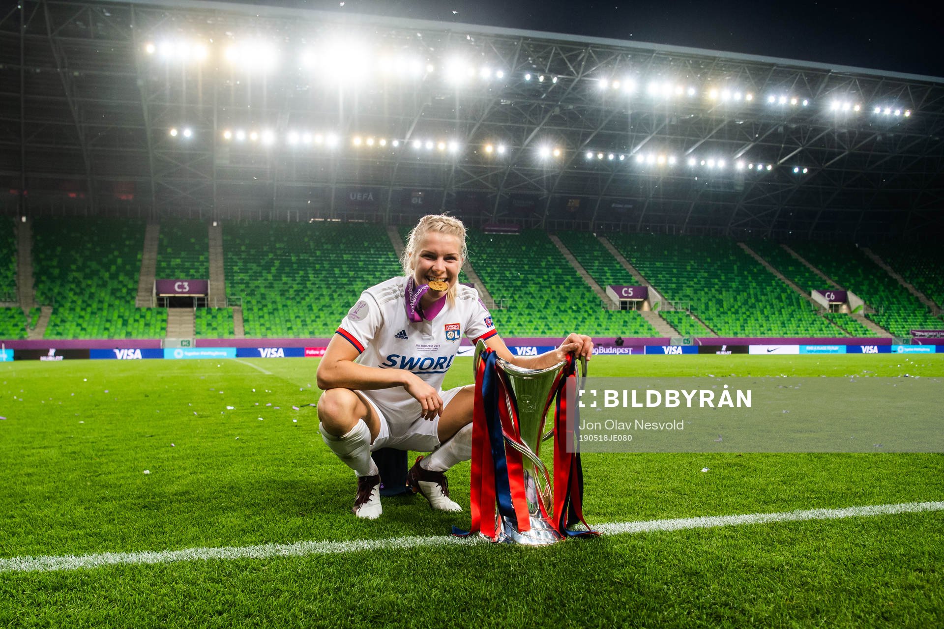 Ada Hegerberg of Lyon poses for a portrait with her gold medal and the trophy after the UEFA Women's Champions League final match between Lyon and Barcelona on May 18, 2019 in Budapest.