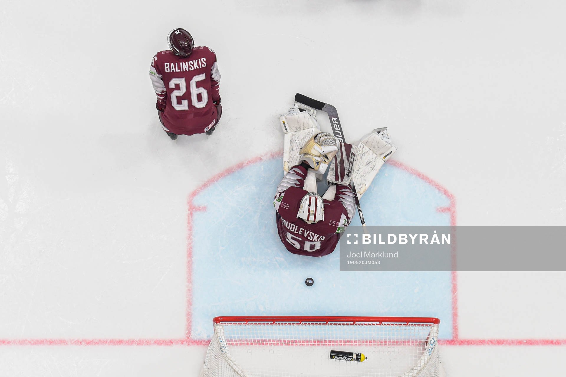 Uvis Balinskis and goaltender Kristers Gudlevskis of Latvia