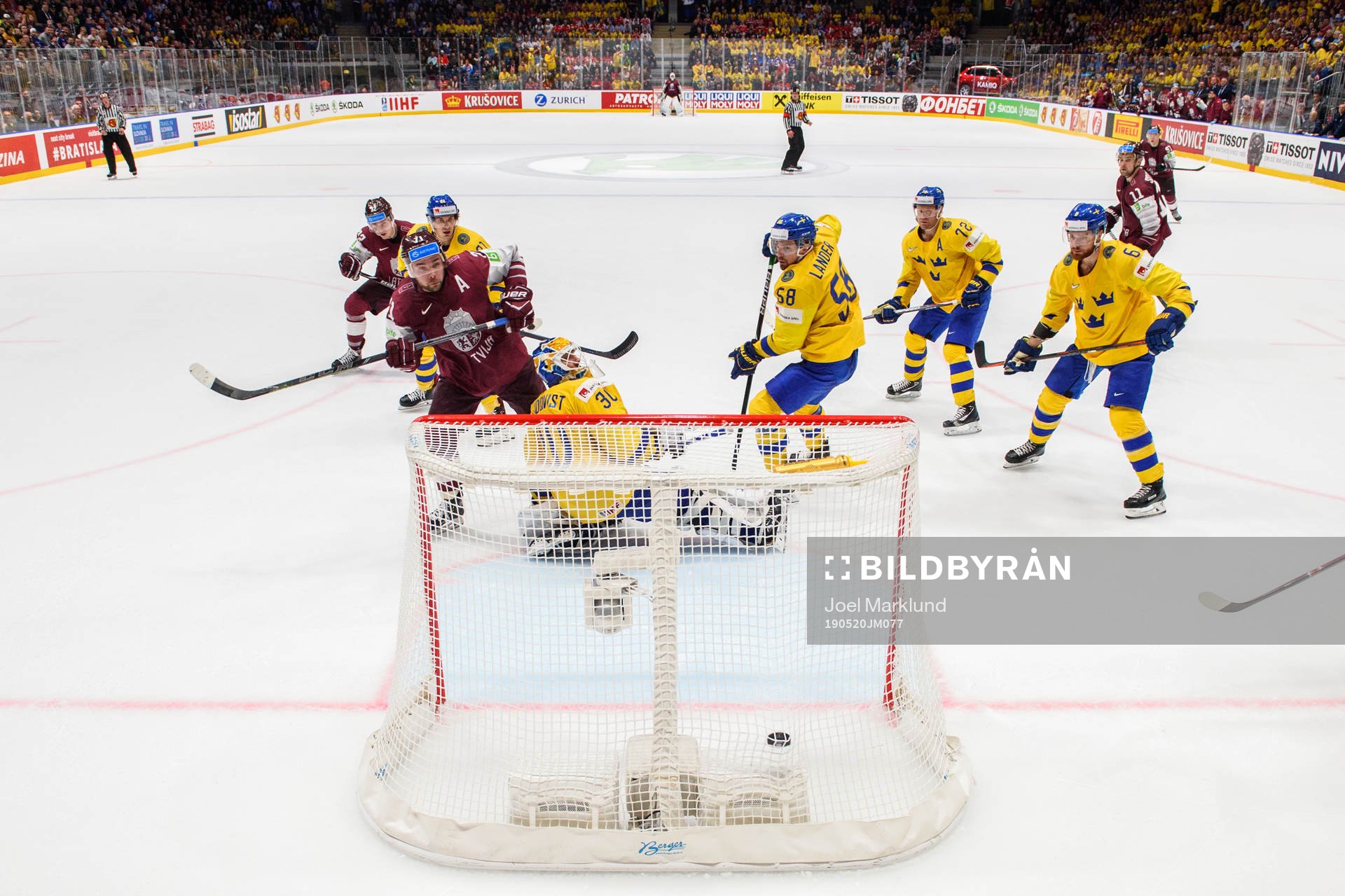 Roberts Bukarts of Latvia score 4-4 behind goaltender