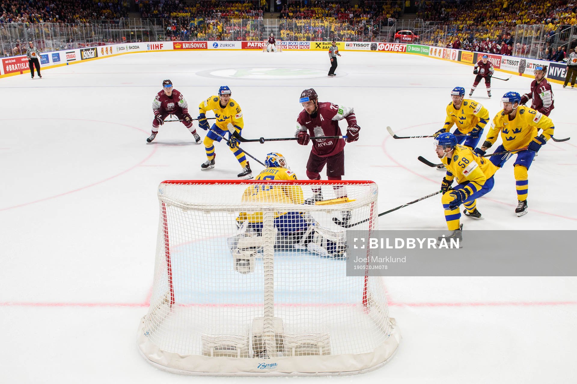Janis Jaks of Latvia score the 4-4 goal behind goaltender