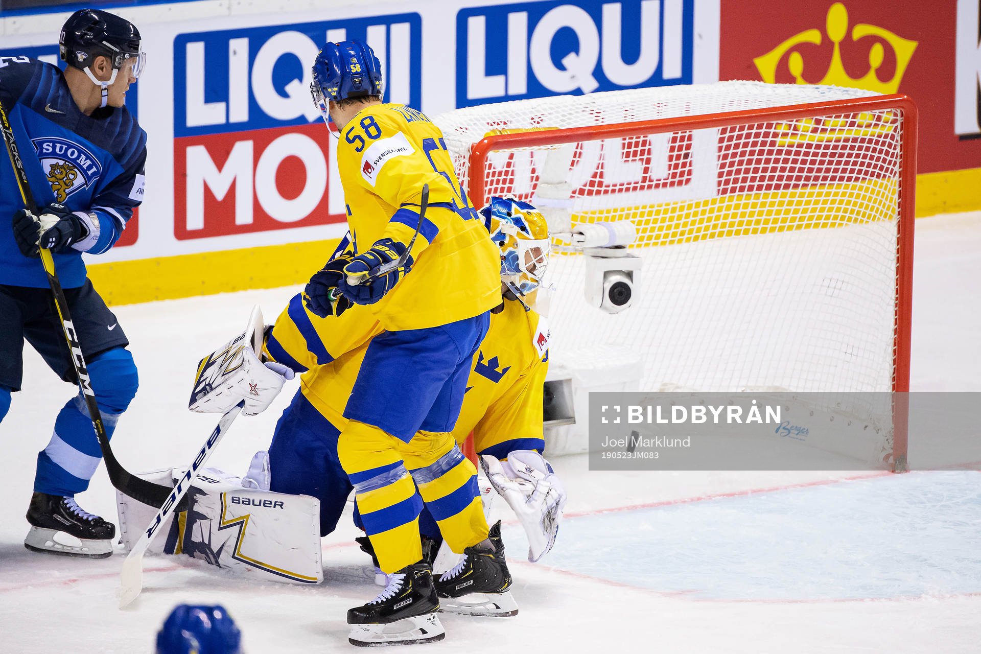 Petteri Lindbohm of Finland scores 2-3 behind goaltender