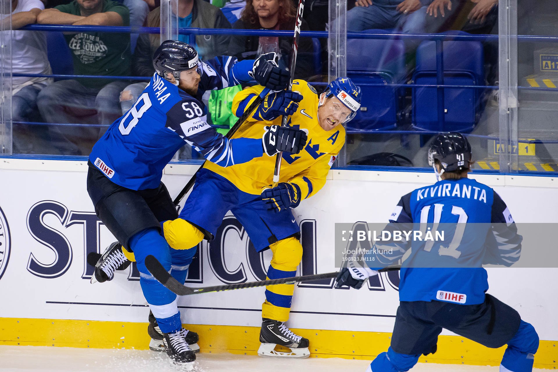 Patric Hörnqvist of Sweden is tackled by Jani Hakanpää